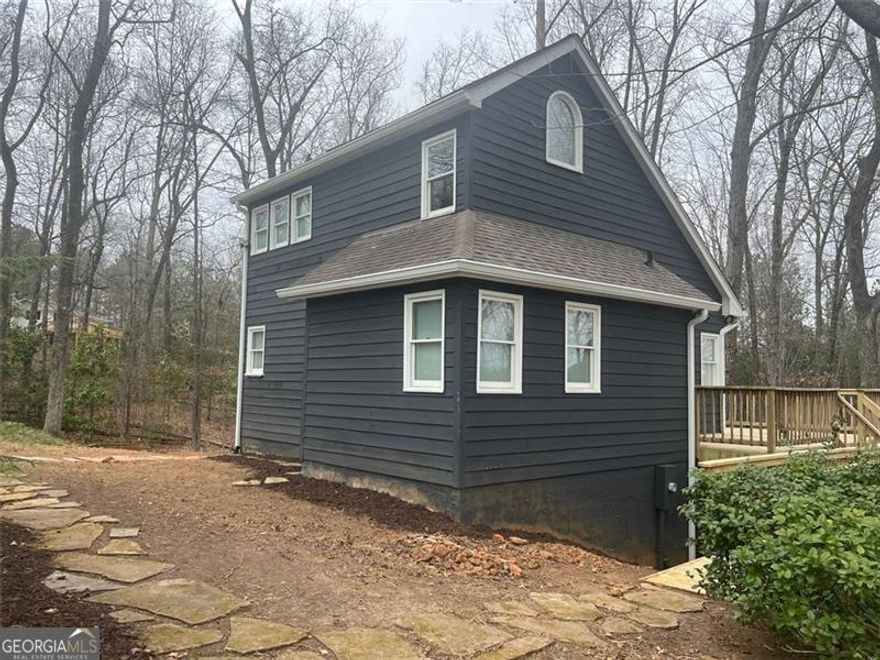 Great location mins to Halycon,Ga 400 and the greenway. Charming Cottage-Style home nestled on a serene, one-acre wooded lot, this charming 3-bedroom, 2-bath . A true hidden gem, it feels like a private retreat while still providing all the conveniences of home.The beautifully updated kitchen features top of the line applanices, while the spacious great room boasts soaring ceilings, creating a bright and inviting living space. The main level also includes a full bathroom with a stunning tiled shower. Upstairs, the loft-style primary bedroom overlooks the main floor and includes a full bath and a walk-in closet. The finished basement provides additional bedroom and storage, a cozy fireplace, and versatile flex space-ideal for a home office, guest area, or second living space. Step outside to embrace the beauty of nature from the expansive wrap-around deck. The home's peaceful and private setting, making it the perfect place to unwind and enjoy wildlife.