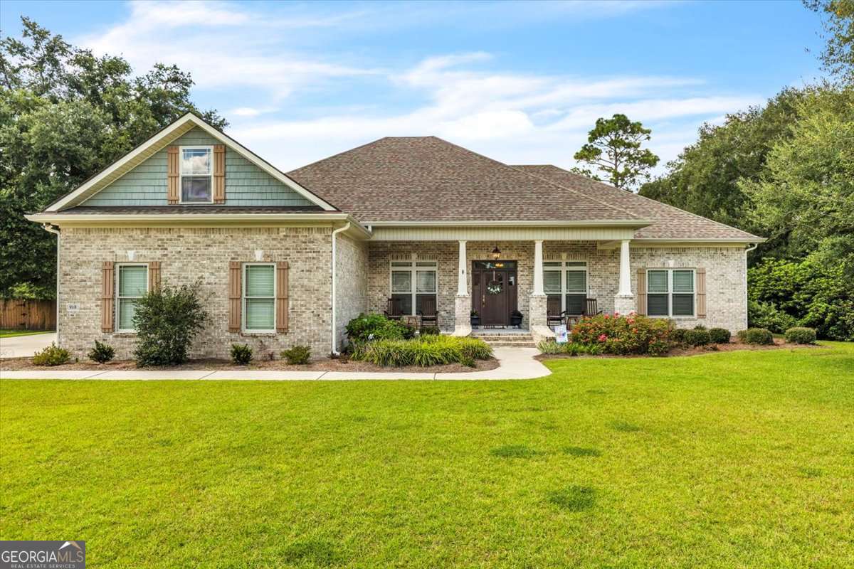 Stunning! This all brick custom home is located less than 1 mile from South Effingham Highschool. Beautiful curb appeal featuring a large covered front porch on .51 acres. Hand-scraped hardwood floors in all common areas, expansive 14ft ceilings, cathedral ceiling in family room that includes a stone veneer floor to ceiling wood burning fireplace. Updated kitchen featuring custom wood soft close cabinets, quartz countertops, & gorgeous porcelain brick flooring. SS appliances, double convection ovens w/ convection microwave & induction cooktop. Spacious bonus room above garage. Split floor plan features primary suite w/ extended space for an office/nursery/workout room, a tray ceiling & two walk in closets. En-suite features double separate vanities w/ a make-up area, marble countertops, whirlpool marble tub & walk-in shower with seat. Enjoy peaceful nights sitting on your screened in back porch or hanging out on the newly installed stone paver patio!