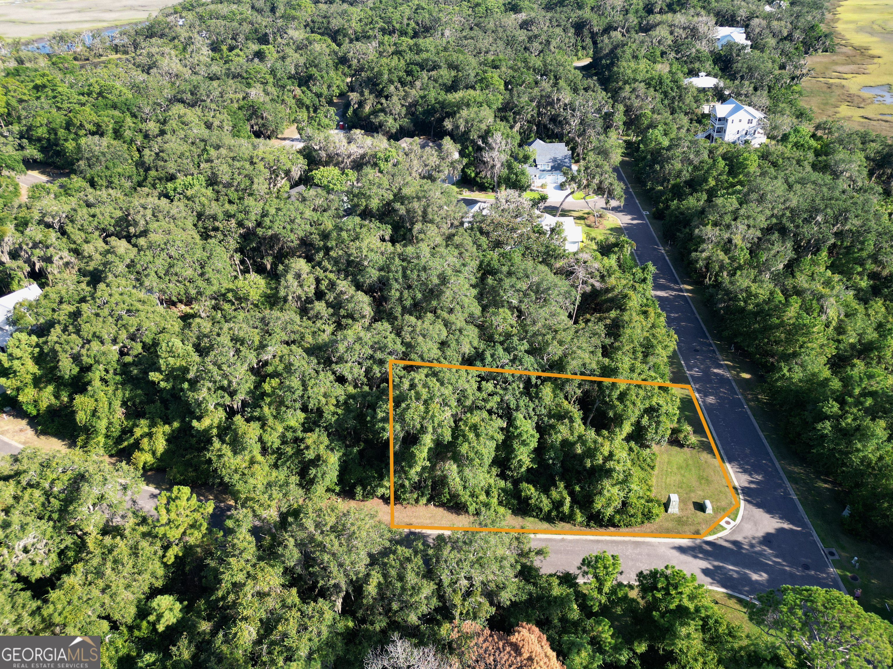 Ready to build your dream getaway? This gorgeous 0.4-acre corner lot is littered with giant oak trees covered in Spanish moss... hello Southern charm! Located just across the street from the marsh, you'll love the peaceful vibe and those peek-a-boo views of the marsh. Set in the private, gated community of Cumberland Harbour, this lot comes with way more than just beautiful surroundings. We're talking resort-style living: a fitness center, clubhouse, lap pool, splash pad, tennis and pickleball courts, boat dock, and even a community beach to kick back and enjoy the salt air. With public water and sewer access once you're ready to build, you can start building your dream home without a hitch. Come live your best coastal life!