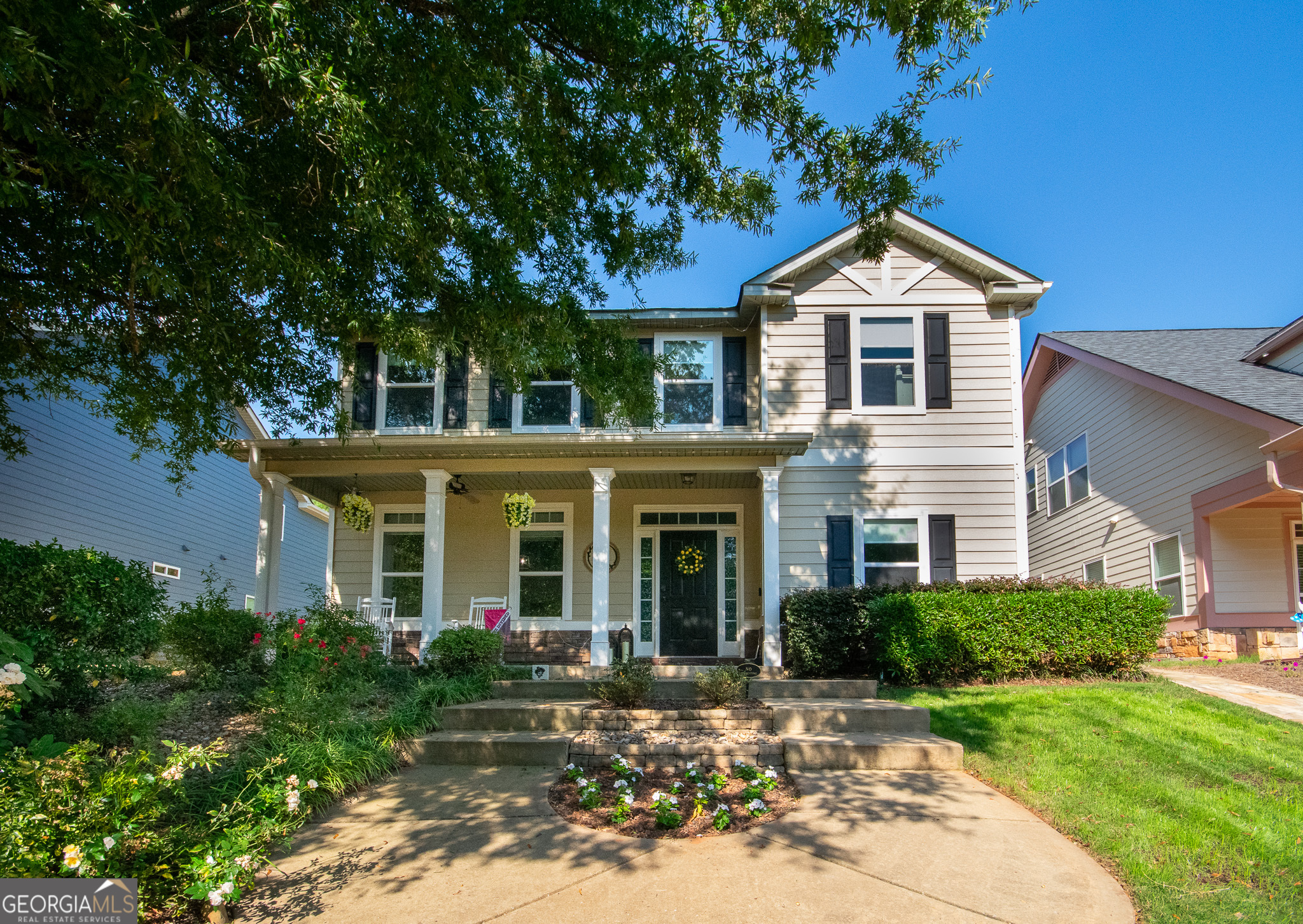 Welcome to this beautifully maintained two-story home offering 4 bedrooms and 3 full baths. The main level features a guest bedroom and bath, while the upper level includes 3 bedrooms, 2 baths, and a convenient laundry closet with the washer and dryer included. The primary suite boasts high ceilings, a walk-in closet, and a double vanity. The open kitchen is designed for entertaining with a breakfast bar, island, pantry, and stainless steel appliances. Interior upgrades include new carpet, fresh light fixtures/fans, smart lighting/locks, and blinds less than a year old. Enjoy cozy evenings by the gas log fireplace or relax on the welcoming front porch. Outdoor living features a fenced yard and garage, with a new garage door to be installed this week. Community amenities include clubhouse, pool, playground, park, sidewalks, and street lights. Cameras convey with the home for added peace of mind.