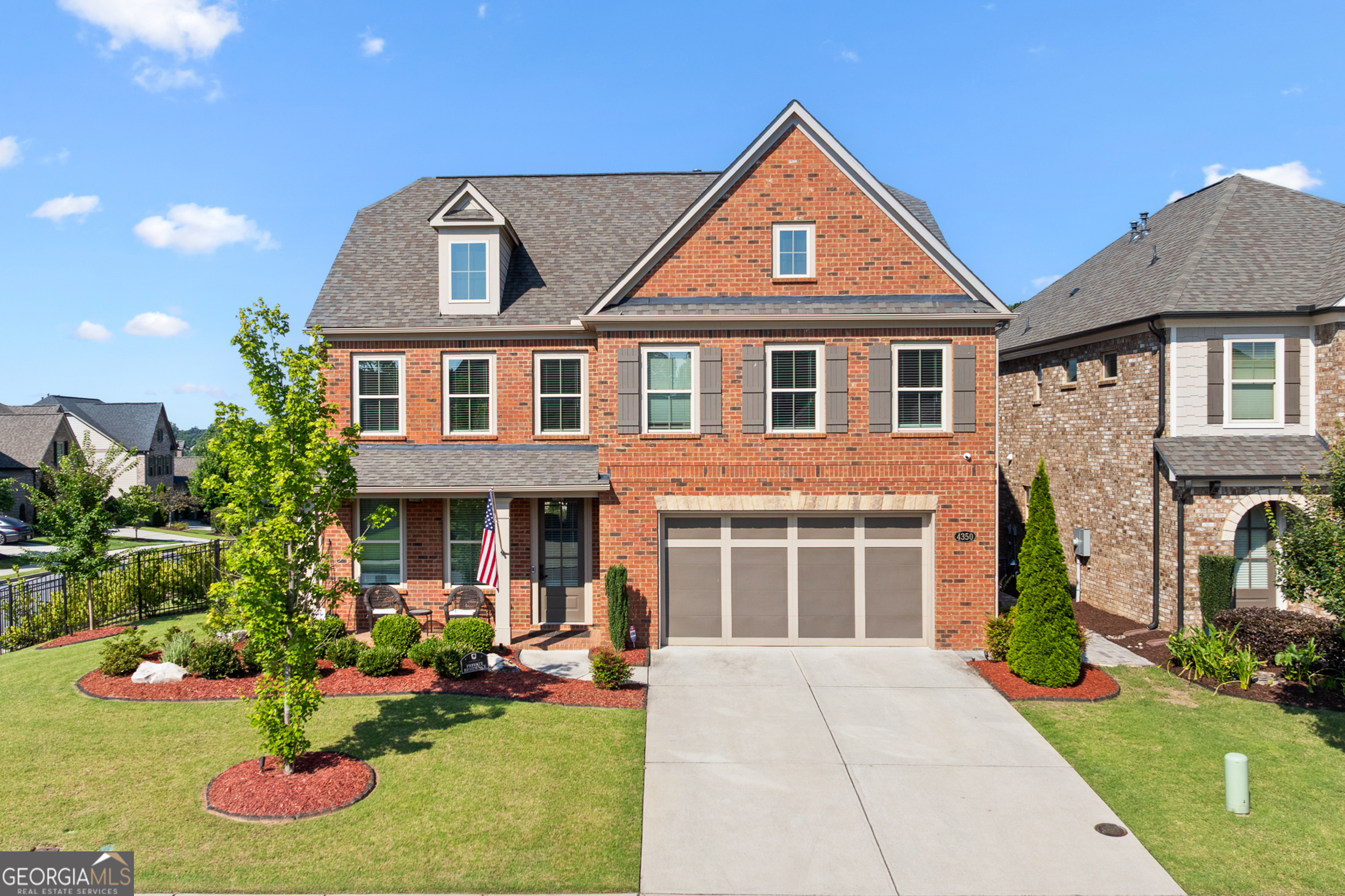 Welcome to this beautifully maintained 3-sided brick home, perfectly situated on a professionally landscaped corner lot in a highly sought-after neighborhood. With 5 bedrooms and 3.5 bathrooms, this home offers space, style, and thoughtful upgrades throughout. Enjoy the flexibility of two luxurious primary suites - one on the main level and another upstairs. The main-level suite features a large walk-in shower and double vanities, while the upstairs suite includes a soaking tub, separate glass shower, and double vanities-perfect for guests or multigenerational living. The heart of the home is the custom-designed kitchen featuring a huge island, breakfast bar, painted cabinetry, walk-in pantry, drawer microwave, farmhouse sink, Insta-Hot purified water system, and a massive gas range-a dream for home chefs. The kitchen opens to a spacious living room with a beautiful fireplace and flows into a bright sunroom that can be closed off for privacy-ideal for a playroom, home office, or additional lounge space. The formal dining room with coffered ceiling provides a sophisticated space for entertaining. Throughout the home, you'll find custom closets, wired sound system, and spacious secondary bedrooms and bathrooms. Step outside to a fully equipped outdoor kitchen with a built-in gas grill, a pergola, and a serene garden space. The full sprinkler system makes maintaining the lush yard effortless, while the corner lot provides added privacy and curb appeal. Additional highlights include a 2-car garage, upgraded lighting, and refined finishes throughout. This home combines comfort, elegance, and function - perfect for everyday living and exceptional entertaining. Schedule your private showing today!