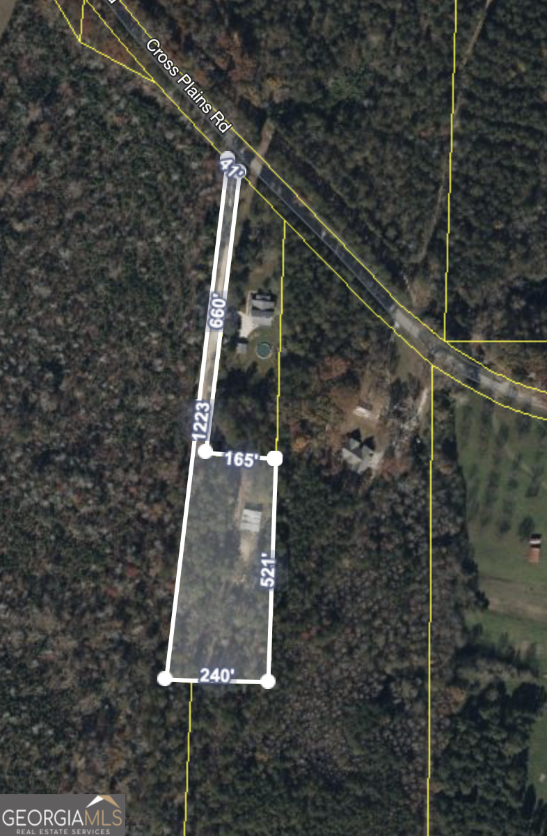 The private lot in Carrollton is zoned for residential use. With its long, private driveway and partially wooded lot, this piece of land could be the next place you call home! Currently, there is a 50x50 workshop on the property. Complete with cement floor, tall ceilings and 3 large bays, its versatility is endless. The workshop also has an electricity pole, although there is no longer electricity running to the shop, and a metal air line around the shop. There is also an old mobile home on the property. There is an easement to access property behind subject property.