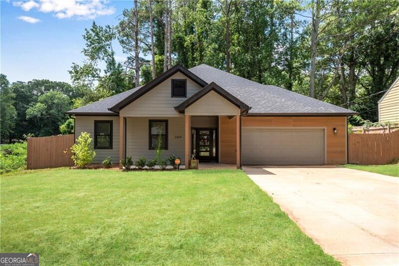 Furnished rental located next door to 5 acres of unbuildable nature reserve space! Hard to find newer construction in East Point! True one level ranch living and ALL ELECTRIC for lower utility bills. Hardwood foyer w/high soaring ceilings extending through-out home. Great room w/linear fireplace and double sets of French doors to the covered patio overlooking the private fenced backyard. High end island kitchen w/furniture venthood, French door fridge and walk-in pantry. Actual walk-in laundry room w/cabinets. Hardwood primary suite w/tray ceiling, desk and sitting areas. Primary bath features a double tile shower, double vanity and spacious walk-in closet. Three secondary bedrooms ALL feature ceiling fans and share a tile half bath w/double vanity. Located near Atlanta's major highways, Hartsfield Jackson International Airport, the Porsche center, and Tyler Perry Studios. Lawn maintenance and trash service included in lease.