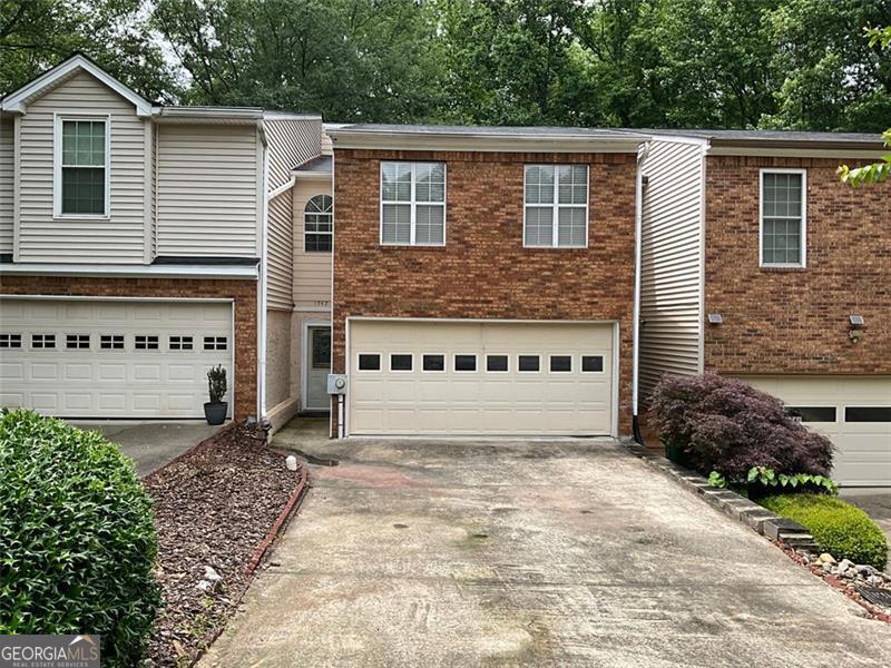Great East Cobb location, highway close and convenient to shopping and other amenities. This open floorplan townhome offers two large bedrooms upstairs, each with private baths, master suite has large walk-in closet, master bath with garden tub, separate tub/shower and double vanities. Laundry room in hallway, spacious open and airy loft that overlooks living room with extra closet space. Main level with updated kitchen, upgraded flooring throughout. Fully finished basement for extra space. Back deck with step down to backyard. Agent is related to property owner.