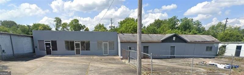 Exceptional investment opportunity in a prime location near Mercer University! This versatile commercial property, zoned C-2, sits on approximately 0.78 acres with 222' of frontage, offering excellent visibility, accessibility, and long-term growth potential. The site features three retail units, including one expansive 3,000 sq. ft. space that is currently vacant and ideal for a variety of uses such as retail, office, restaurant, or service-based business. The space can also be subdivided into two units, creating flexibility and maximizing future rental income. The two additional retail units are currently leased, providing $1,500/month in steady income. Adding significant value, the property includes three separate storage buildings with a combined 39 units. Storage mix includes 24 units at 10x12 and 15 units at 5x10, creating diverse rental options and an additional income stream. Square footage includes the storage facilities, further enhancing the overall property appeal. The building has undergone several updates, including new exterior paint, roof updates, updated plumbing and electrical systems, and partially completed new flooring. Current tenants pay for their own water and handle repairs within their units, helping to minimize owner expenses. With its C-2 zoning and proximity to Mercer University, this property benefits from consistent demand from students, faculty, and the surrounding residential community. Whether you are seeking a strong income-producing investment, a property for owner occupancy with supplemental rental income, or a redevelopment opportunity, this offering provides endless potential in one of the area's most desirable commercial corridors.