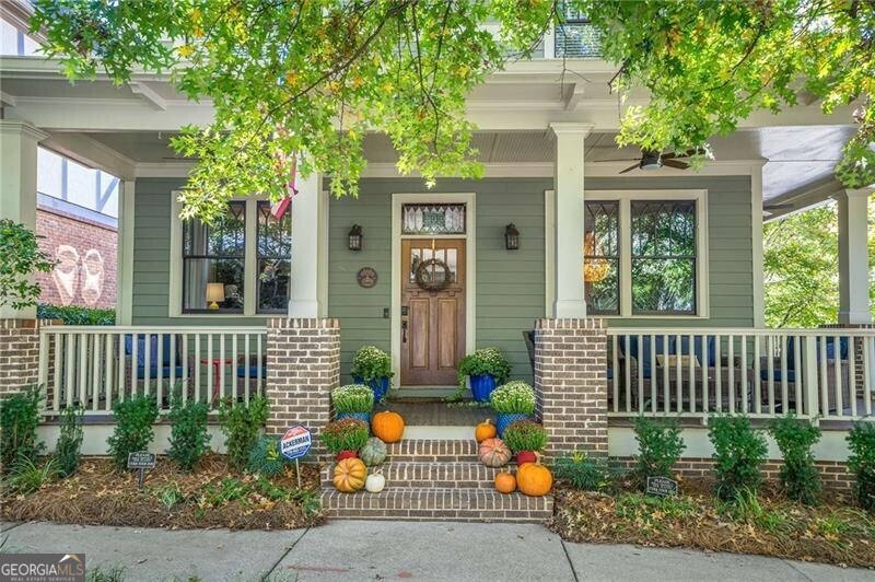 Nestled in the heart of Glenwood Park, this rare find pairs true Intown living with the comforts of a spacious suburban home, minus the yard work. The main residence offers 4 bedrooms and 3.5 baths with a coveted primary suite on the main level complete with its own private laundry. An open, light-filled floor plan flows effortlessly from the chef's kitchen to a beautifully landscaped courtyard, perfect for dinners and weekend gatherings and the wrap-around porch is made for morning coffee or sunset cocktails. Upstairs, generous secondary bedrooms and additional laundry make everyday living easy. A partially finished basement (plumbed for a future bath) and a hard-to-find 3-car garage deliver storage and flexibility galore. Need more space or versatility? An attached ADU/in-law suite features a studio layout with a full kitchen and bath, ideal for guests, multigenerational living, a private office, or potential RENTAL! Living in Glenwood Park means a true live-work-play lifestyle with the Atlanta BeltLine at your doorstep, beloved restaurants, bars and shops just steps away, and community events all through the year such as the Glenwood Park Halloween Parade, the holiday tree lighting in Brasfield Square, Parktoberfest in Brewer Park and the annual Easter Egg hunt, just to name a few. Optional neighborhood pool & gym membership, a private dog park, and community gardening plots round out the amenities. Schedule your private tour today and experience Glenwood Park living at its best.