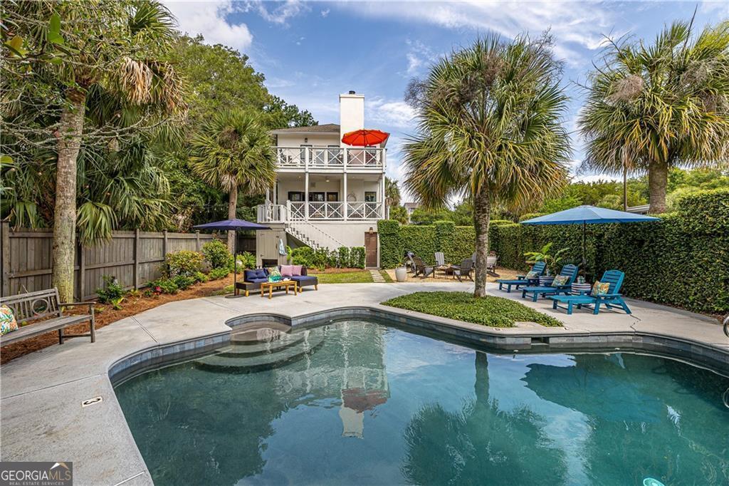 Be steps from the sugar-soft sands of East Beach-this exquisite 4-bed, 4.5-bath bungalow isn't just a home; it's a passport to coastal bliss. The backyard is a private oasis, where a shimmering pool enjoys the perfect balance of dappled shade and golden light. The primary suite is a retreat within a retreat, boasting its own private porch-your front-row seat to serenity. The living room sets the stage for relaxed luxury, where coastal breezes flow through sunlit spaces. Just beyond, the covered second-floor porch offers a tranquil perch overlooking the lush backyard, perfect for morning coffee or evening toasts. Back inside, the kitchen is a masterpiece of form and function, adorned with lustrous stone countertops that elevate every culinary creation. This is more than a residence-it's an invitation to an elevated seaside lifestyle where luxury and leisure intertwine. This beautiful home is being sold fully furnished. Take the 3D tour.