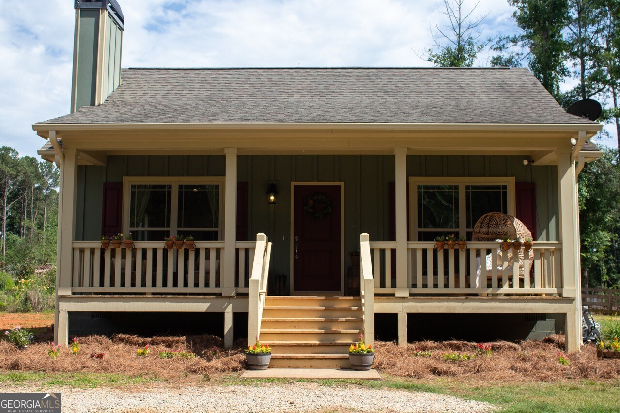 Charming Country Retreat on 10 Acres - Minutes from I-20 & Lake Oconee! Welcome to your peaceful paradise! This beautifully maintained 2 bed, 2 bath farm home sits on a sprawling 10-acre tract of fenced agricultural land--perfect for those looking for a small farm, space, privacy, and a true slice of the country lifestyle. Step onto the inviting front porch and enter into a light-filled open floor plan featuring luxury vinyl flooring, a cozy stone fireplace with hearth, and a stunning 5' granite island anchoring the spacious kitchen. Enjoy granite counter tops, modern appliances, and ample cabinetry--ideal for everyday living and entertaining alike. The primary suite offers a generous walk-in closet and private bath, while the split-bedroom layout ensures privacy for guests or family. Outdoors, the property truly shines. This home is zoned agricultural and is currently hosting goats, donkeys, horses and more. A wonderful farm. The tract is flat usable farm land with plenty of room to roam. There is also ample room for an RV or trailer to turn around. A barn and large shed also sit on this property. The shed is perfect for hobbies, storage or a creative studio. Over 3000 feet of invisible extreme dog fencing is another added bonus to this property. The property is fenced and the entrance is gated. Located just minutes from I-20, Shops, Lake Oconee Academy, and area amenities--yet surrounded by nature and serenity--this unique property is a rare find. Don't miss your chance to live the farm life without giving up convenience!