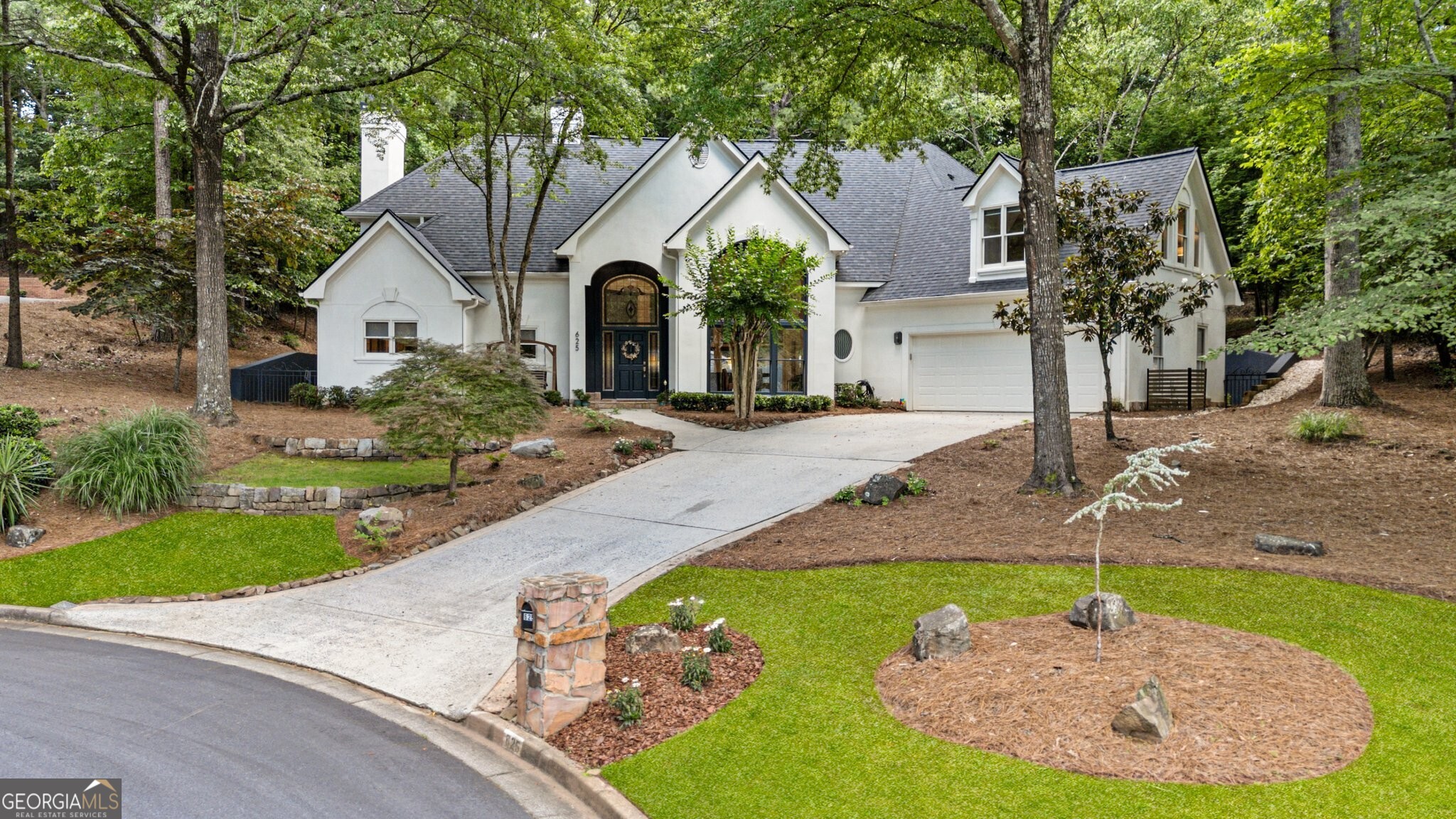 Welcome to this beautifully updated home located in this quiet cul-de-sac in the estates section of Horseshoe Bend subdivision located in Roswell! This stunning residence offers an elegant primary bedroom conveniently located on the main level, complete with an updated spa-like retreat featuring a separate shower, luxurious garden tub, updated lighting and fixtures with dual vanities. Enjoy views from the large picture windows that frame the private backyard complete with a tranquil spa and waterfall-perfect for relaxation. As you enter the home you are welcomed with the most spectacular two-story great room with large picture windows letting abundant natural light pour in through expansive windows allowing you to connect with the outdoors from the comfort of your home year-round. The stone fireplace in the great room or keeping room is ideal for cozy gathering places and one of four fireplaces in the home! The floor plan is designed for entertaining and offers an expansive kitchen with ample counter space, updated backsplash, and stylish hardware that flows seamlessly into the keeping room and breakfast area. This home has been meticulously upgraded with newer HVAC, new upgraded roof, updated flooring throughout including beautiful hardwoods and carpet. Additional enhancements such as updated lighting and bathrooms create a fresh and inviting atmosphere. Upstairs find an office or media room with a fireplace and built-in bookcases. On the other side of the home are two spacious bedrooms with an updated bathroom as well as a bonus room that can be the perfect space for a rec room, craft space, playroom or fitness space. The entire home offers lots of closets and storage space. Walk outside to a park like backyard that you can see from every window on the main level. This outdoor space offers beautiful privacy, green space and a small pool/spa with fountain to create a complete outdoor oasis. Nestled in peaceful cul-de-sac, this home is part of a community, and the country club offers memberships that include golf, tennis, pool, fitness center, dining options and walking trails. Just minutes to GA 400 as well as downtown Roswell shops and restaurants, Avalon and downtown Alpharetta. Don't miss the opportunity to make this exceptional property your own-schedule a tour today and experience the perfect blend of comfort, style, and community living!