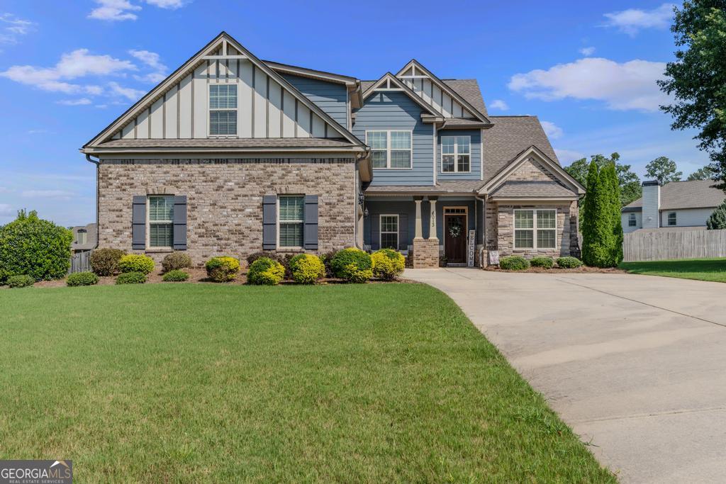Welcome Home! This stunning 4 bedroom, 2.5 bath home is located in a desirable gated community and offers the perfect blend of comfort, style, and privacy. From the charming rocking chair front porch to the fenced backyard oasis with a covered extended patio, this home has incredible curb appeal and outdoor living space. Inside, you'll find hardwood floors throughout the main living areas, an open floor plan, and a beautifully upgraded kitchen with a large island, stainless steel appliances, double oven, gas cooktop, and tile backsplash-perfect for entertaining. The kitchen opens to a cozy fireside family room. The primary suite is conveniently located on the main level, featuring a spa-like bathroom with a tile walk-in shower. Upstairs includes a large suite ideal for guests or teens, along with two additional spacious bedrooms and a shared bath. This home is full of thoughtful upgrades and located in a quiet, gated neighborhood. Don't miss your chance-schedule your private showing today!
