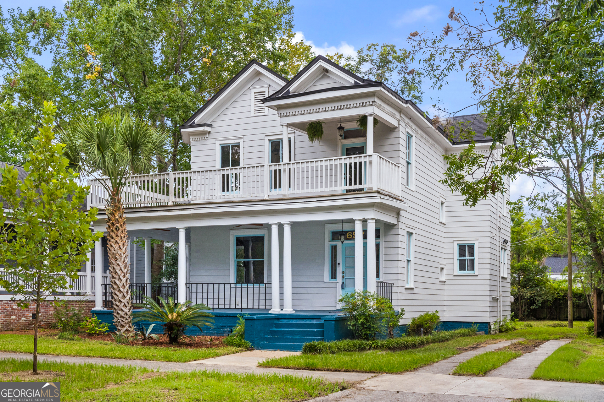 Experience the perfect marriage of historic Savannah charm and chic modern luxury. Expansive wrap-around porches on two levels welcome you, promising serene mornings with coffee and relaxed evenings with cocktails. Inside, soaring ceilings and rich hardwood floors flow through large, sun-drenched rooms. The gourmet kitchen is an entertainer's delight with granite countertops and stainless steel appliances. Retreat to the renovated bath, a true sanctuary boasting a romantic clawfoot tub and elegant double vanities. Your private paradise awaits outside on a rare double lot, dotted with fruit trees and offering endless space to unwind. With coveted off-street parking and a large storage shed, every convenience is met. This is more than a home; its an enchanting Southern lifestyle waiting to be claimed.