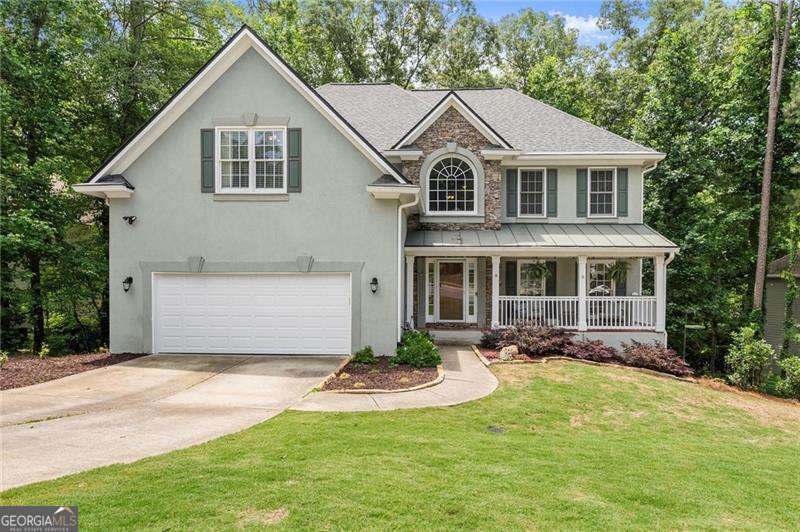 Get ready to fall in love with 2342 Tall Timbers Lane - a picture-perfect corner-lot gem tucked into one of Marietta's most charming and well-kept neighborhoods, where the HOA fees are low and the community pride runs high. Located in a top-rated school district, this home offers the best of both worlds: peaceful surroundings with everyday conveniences just minutes away. Start your mornings or wind down your evenings on the front porch, where the sunset views are simply unmatched - it's your personal front-row seat to Georgia's golden hour. Step inside and you'll immediately feel the flow of the open, sunlit floorplan. The main level is made for entertaining and easy living, featuring soothing paint color, a spacious dining room, a kitchen that opens right into the soaring, two-story living room, and a flexible bonus space perfect for a home office, library, or play area. Upstairs, a cozy loft with built-in bookshelves offers a quiet corner for reading, working, or just hanging out. The primary suite is your private retreat, with a huge walk-in closet and a spacious bathroom complete with double vanities and a soaking tub that practically begs you to relax. There's more- the fully finished lower level is a total game changer! Complete with its own kitchen, living area, and full bathroom, plus two extra bedrooms, it's the ideal setup for guests, or multi-generational living. And with an abundance of storage space, you'll have a place for everything. Outside, multiple levels of brand-new decks overlook a partially fenced backyard - perfect for pets to play safely. Beyond the fence, explore your own wooded wonderland with a peaceful creek running along the rear. Whether you're hosting a cookout, sipping coffee in the morning sun, or taking an afternoon stroll through the trees, this outdoor space truly sets this home apart. Come see it for yourself and discover why this home is the one you've been waiting for!