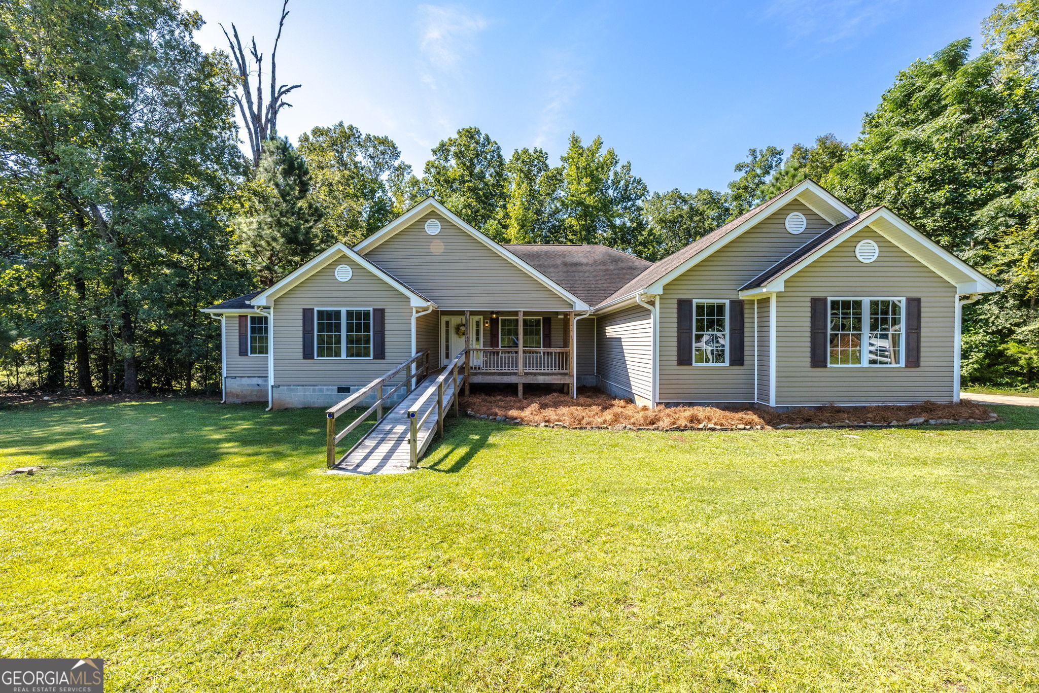 A Place with Space! Set on 5.7 private acres in Monroe County, this 3 Bedroom, 2.5 Bath one-level home offers the perfect blend of comfort, space, and low-maintenance living. Inside, you'll find spacious rooms and an open floor plan designed for easy everyday living. The updated kitchen features brand-new appliances and opens to both the great room and the keeping room, giving you plenty of space to spread out or entertain. Large laundry room. Practical updates include HVAC units that are just two years old, plus county water availability for convenience. Deck overlooks wooded back yard. 2 car garage. The tall crawl space provides additional storage options, while the surrounding acreage ensures a peaceful, secluded setting with exceptional privacy.