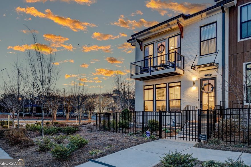 INCREDIBLE OPPORTUNITY - END UNIT - This desirable 3 story townhome includes a private bedroom on the terrace level with full bath & spacious walk-in closet + entry on Main Level. Main Level offers a Gourmet Kitchen with sought-after, modern features such as Calacatta Alto MSI Quartz Countertops, White Cabinets w/ soft close doors & under cabinet lighting, GE Stainless Steel Appliances, Walk-In Pantry, & more! Behind the Kitchen you will find a Sunroom, perfect for an office or separate dining space w/ entry to the deck + half bath, & two separate storage closets. Kitchen Island overlooks the open concept Dining & Living Room. Centered in the Living Room is a contemporary linear fireplace w/ wood mantel & stacked stone surround. Staircase leading from the Main Level to the Upper-Level features metal balusters, w/ Stained Oak handrail and Oak Treads! On the Upper-Level, you will find an oversized Owner's Suite with tray ceilings and large walk-in closet! Owner's Suite Bathroom includes dual vanities, linen closet, spacious shower w/ frameless door, & separate water closet. 2 car garage + driveway long enough to park two additional cars. You cannot beat this location! Just minutes away from numerous dining options, retail space, trails, & more! 0.2 miles from North Point Mall, 0.7 miles from the Big Creek Greenway entrance, 1.9 miles from Downtown Alpharetta, 2 miles from Avalon, & direct entrance to the future Alpha Loop Extension.