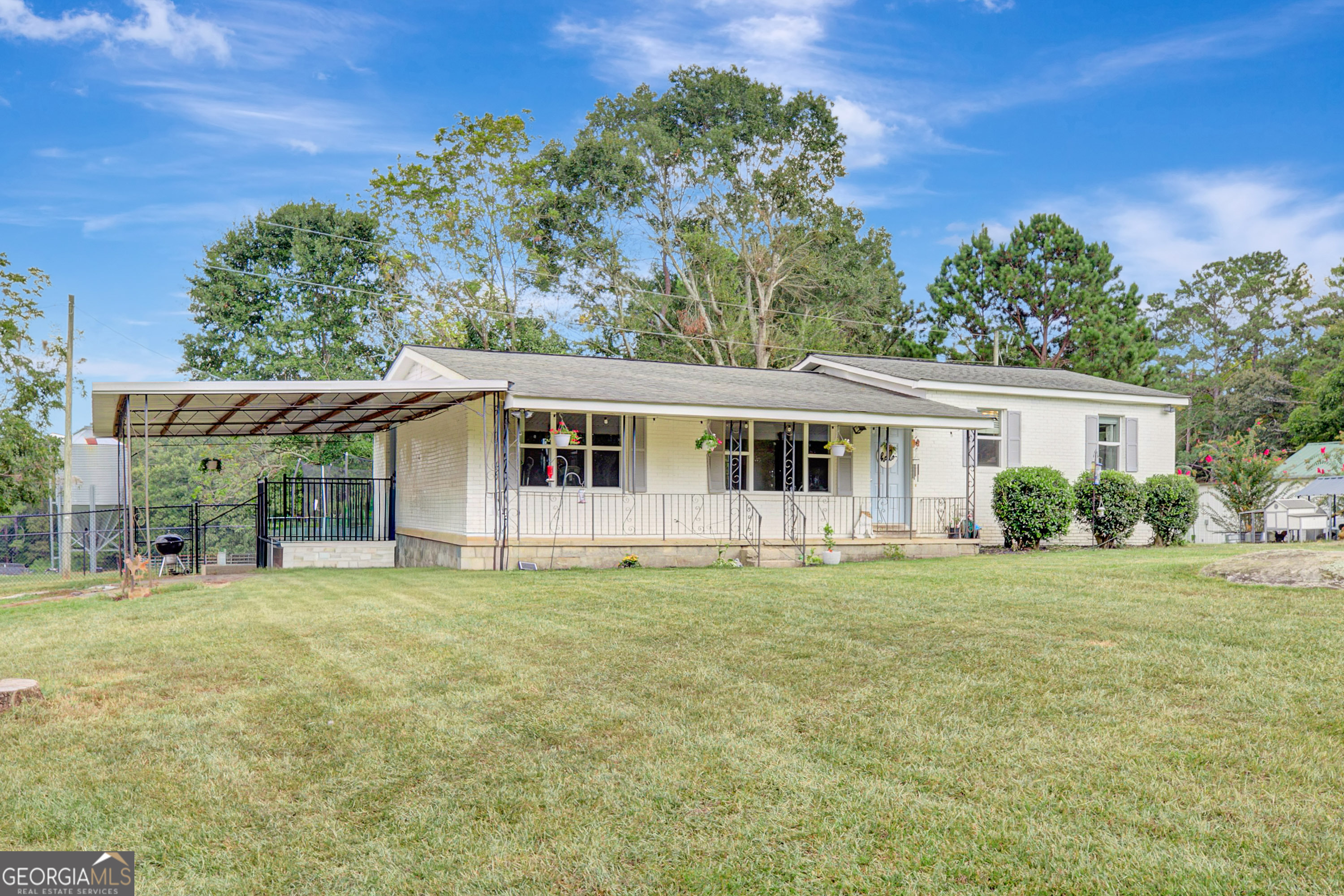 Welcome to this charming full Brick ranch-style home nestled on 1.19 acres in the highly sought-after town of Brooks, GA, known for its peaceful country setting and excellent school districts. Surrounded by rolling farmland, this property offers the perfect blend of country living and convenience. A covered front porch sets the tone for relaxed living, while the covered parking pad adds everyday functionality. Inside, you'll find a spacious kitchen with abundant cabinetry, granite countertops, stainless steel appliances, a breakfast area, New LVP flooring and fresh paint through-out. The laundry closet is conveniently located in the kitchen for easy access. The family room is warm and inviting, featuring newer windows that flood the space with natural light, smooth ceilings, recessed lighting, and a cozy brick fireplace. Just a step up leads you to the bedroom wing, where you'll find a full hallway bath with tile flooring, a comfortable secondary bedroom, and a private owner's suite complete with a tub/shower combo and a walk-in closet with built-in shelving. Additional highlights include a new back deck, updated ductwork, chicken coop, and a fully fenced in property perfect for pets or a hobby farm. An additional fenced in area is ready for all your pets. This move-in ready home has all of the country charm and offers plenty of room to enjoy peaceful living in Brooks.
