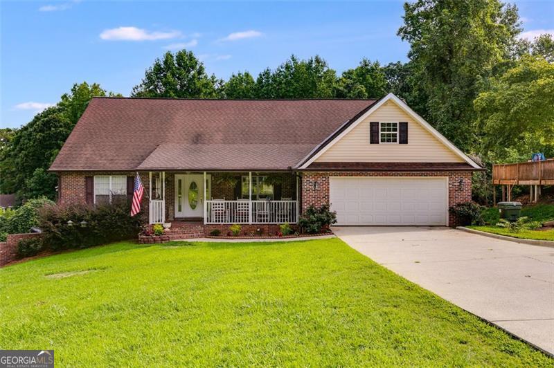Welcome home to this maintenance free ranch nestled on 3.2 acres! The rocking chair front porch invites you in to this 3 bed 2.5 bath home. The spacious great room sets the stage for cozy evenings with loved ones. The bright open kitchen features a breakfast bar, custom cabinetry and leads to a separate dining room for entertaining guests. The split bedroom plan boasts an oversized master suite with a large walk in closet and the en-suite bath has a separate tub and shower. The secondary bedrooms are sizeable and share a bathroom between them. The delightful screened in back deck is perfect for enjoying the night air. Need more room you say? The huge unfinished basement can be completed to provide additional space for your needs. Less than 30 minutes from Atlanta and the Battery with easy access to I-285 and I-20. No HOA so come park your toys here!