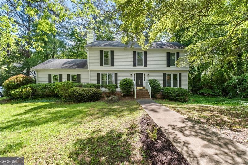 Truly move-in ready and fully updated 3-story home located in one of Atlanta's top 3 school districts! This spacious 5BR/3.5BA home offers a fully remodeled daylight basement with new flooring, updated full bath, and private exterior entry-perfect for in-law suite, guests, or rental income. New under-decking with advanced lighting expands your outdoor living space. Home features all-new windows, upstairs HVAC, hot water heater, oven, microwave, and newer garage doors. Kitchen, all bathrooms, and basement have been completely remodeled. New hardwood staircase and wood floors throughout. Oversized owner's suite includes private deck. Enjoy peaceful mornings or relaxing evenings on the two-level deck in this private, wooded setting. Side yard extends to the right and has room for a pool-several homes in the community have done so. Interior freshly painted in 2024; exterior painted in 2023. Located in a quiet, established neighborhood just minutes from the Braves Stadium, The Battery, top dining, shopping, and major highways. 12-month home warranty included. All major systems and finishes updated within the last 1-3 years. A rare private retreat with unbeatable location and top-rated schools-this one is a must-see!