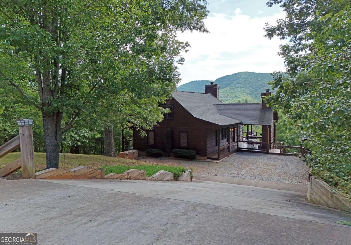 5BR, 4BA PRIVATE MOUNTAIN Views Hot Tub Turnkey Ready. This charming cabin, cherished by its owners for years, the Bearish Blends, Rustic Charm with Modern Comforts, beautifully blends rustic charm with modern comforts. It features an inviting open living space and a cozy stone outdoor fireplace. Nestled in a private cul-de-sac setting, it offers outdoor space for parking guests and recreational vehicles, making it perfect for both personal escapes and vacation rentals. With a proven past rental history, this property provides an excellent investment opportunity while still allowing for cherished family memories. This serene mountain getaway is the perfect blend of rustic charm and modern comfort, ideally located between Blue Ridge, GA, and Murphy, NC. Inside, you'll find spacious living areas, warm wood finishes, and an open floor plan designed for both entertaining and relaxation. Gather with family and friends by the outdoor wood-burning fireplace, enjoy the firepit, unwind in the private hot tub, or sip your morning coffee while taking in the peaceful mountain scenery from the expansive deck. The downstairs features two additional bedrooms along with a recreational setting or an escape to peaceful porch swings right outside the basement door. Whether you're seeking a full-time residence, vacation getaway, or investment opportunity, this cabin is turnkey rental ready (currently not operating as a short-term rental) and comes fully furnished. This unique bear haven is a breeze to start enjoying. Outdoor enthusiasts will love the proximity to Lake Blue Ridge, Nottely Lake, and the Toccoa River-perfect for trout fishing, kayaking, or tubing. Spend your days exploring local wineries, breweries, and distilleries, or simply relax and take in the serenity of mountain living. This is a rare opportunity to own a well-deserved mountain retreat with comfort, convenience, and income potential. See the Unique Bear Haven-all in one unforgettable setting.
