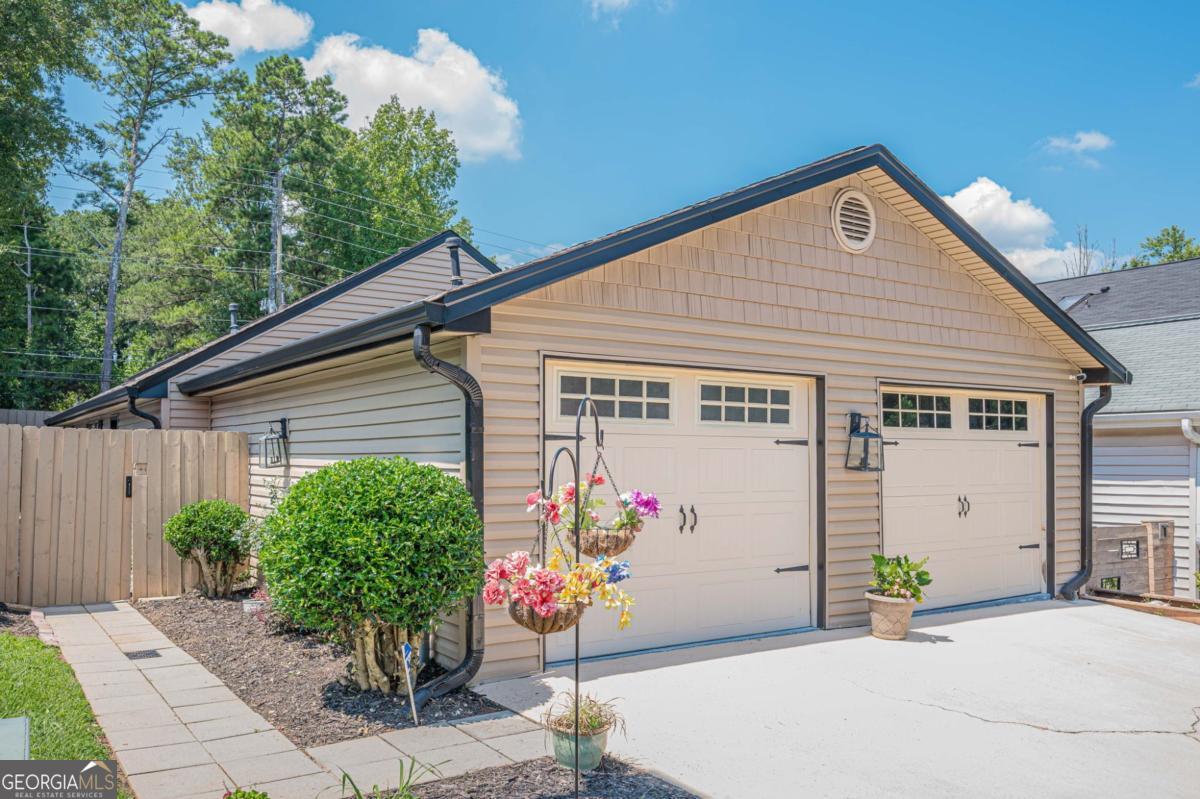 LOCATION, UPGRADES, AND CHARM - THIS ONE HAS IT ALL! Welcome to 936 Bobcat Ct SE, a beautifully updated and move-in ready ranch in the heart of Marietta! Tucked away in a quiet, friendly community with low HOA dues and a community pool, this 2-bedroom, 2-bath home offers the perfect blend of comfort, style, and convenience. Recent updates elevate this home to the next level, including brand new flooring throughout, a gorgeous new master bathroom shower, and a new privacy fence-perfect for pets, outdoor entertaining, or simply relaxing in your own backyard oasis. Step inside to discover a spacious, open-concept family room featuring a stunning stone fireplace, ideal for cozy nights in. The large kitchen boasts quartz countertops, ample cabinetry, stainless steel appliances, and a sunny breakfast area-a great space for everyday meals or morning coffee. The primary suite offers a peaceful retreat with its updated en-suite bath and generous closet space. An oversized two-car garage provides plenty of room for storage, parking, or the potential for future living space. All of this, just minutes from Truist Park, The Battery, shopping, dining, major highways, parks, and everything East Cobb has to offer. Whether you're a first-time buyer, downsizing, or looking for a fantastic investment, this charming home checks all the boxes. Don't wait-schedule your showing today. Homes like this don't stay on the market long!