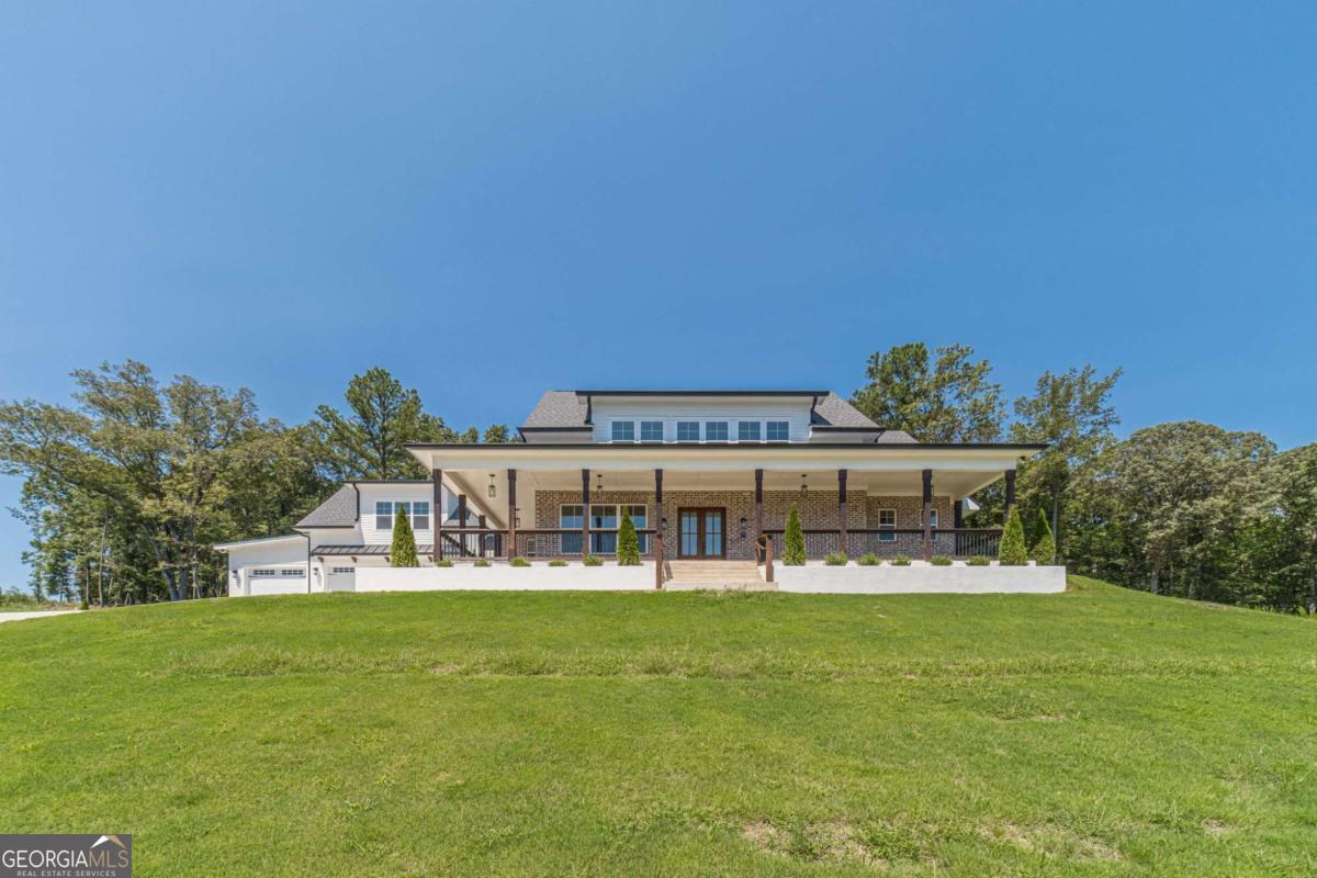 Luxury New Construction Home in Dacula - Over 4,300 Sq. Ft. on 1 Acre! - Welcome to your dream home in the prestigious Hog Mountain community in Dacula, GA! This brand-new construction boasts 5 bedrooms, 4.5 bathrooms, and a spacious 3-car garage-perfect for modern living. Step inside to find solid hardwood floors, elegant lighting fixtures, and a bright, open floor plan. The main-level owner's suite is a true retreat, featuring two walk-in closets, a spa-like bathroom with a double vanity, a soaking tub, a separate shower, and stunning views. The chef's kitchen is a showstopper, featuring white cabinets, quartz countertops, stainless steel appliances, a large kitchen island, and a walk-in pantry! - Upstairs, you'll find additional spacious bedrooms, including a second master suite, plus Bluetooth ceiling fans for added convenience. - Enjoy outdoor living on the front porch or rear porch, surrounded by your 1-acre lot with a long driveway for extra parking. This home truly has it all-modern design, prime location, and plenty of space. Don't miss out on this rare find!