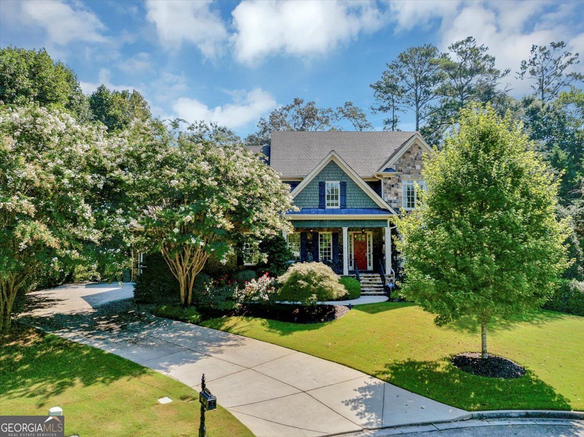 Nestled in an exclusive enclave of just eight homes near the lively Smyrna Market Village, this five-bedroom sanctuary masterfully combines timeless elegance with modern comfort for an unparalleled luxury lifestyle. At its core lies a recently renovated, chef-inspired gourmet kitchen, equipped with premium Wolf and Bosch appliances-including a professional-grade stove, double ovens with warming drawer, and Sub-Zero refrigerator. A generous island with breakfast bar, walk-in pantry, and sunlit breakfast nook make it ideal for both grand entertaining and cozy family gatherings. The adjoining family room, with its soaring vaulted ceiling, invites relaxation and seamless indoor-outdoor flow to a screened porch featuring Eze Breeze windows and a cozy gas-log fireplace. Savor morning coffee overlooking the private, fenced backyard. There is also a main floor guest room. Upstairs, the serene owner's suite serves as a private oasis, boasting a completely remodeled bath with dual vanities, a custom walk-in closet, and a separate shower and tub. Two additional bedrooms plus a bedroom/flex space and two full baths provide versatile space for family or guests. The fully finished terrace level redefines entertainment: a state-of-the-art Dolby Atmos 9.2 theater with a 110-inch screen, an authentic Irish-style bar, dedicated game and den areas, plus an office/flex space and full bath. Direct backyard access enhances effortless al fresco living amid beautifully landscaped grounds. Throughout, hardwood floors grace the main level, while a three-car garage and ample storage ensure practicality meets sophistication. Recent upgrades include a brand-new roof, all new HVAC units and a new privacy fence. This rare gem offers the ultimate in privacy, luxury, and convenience. Your elevated retreat awaits.