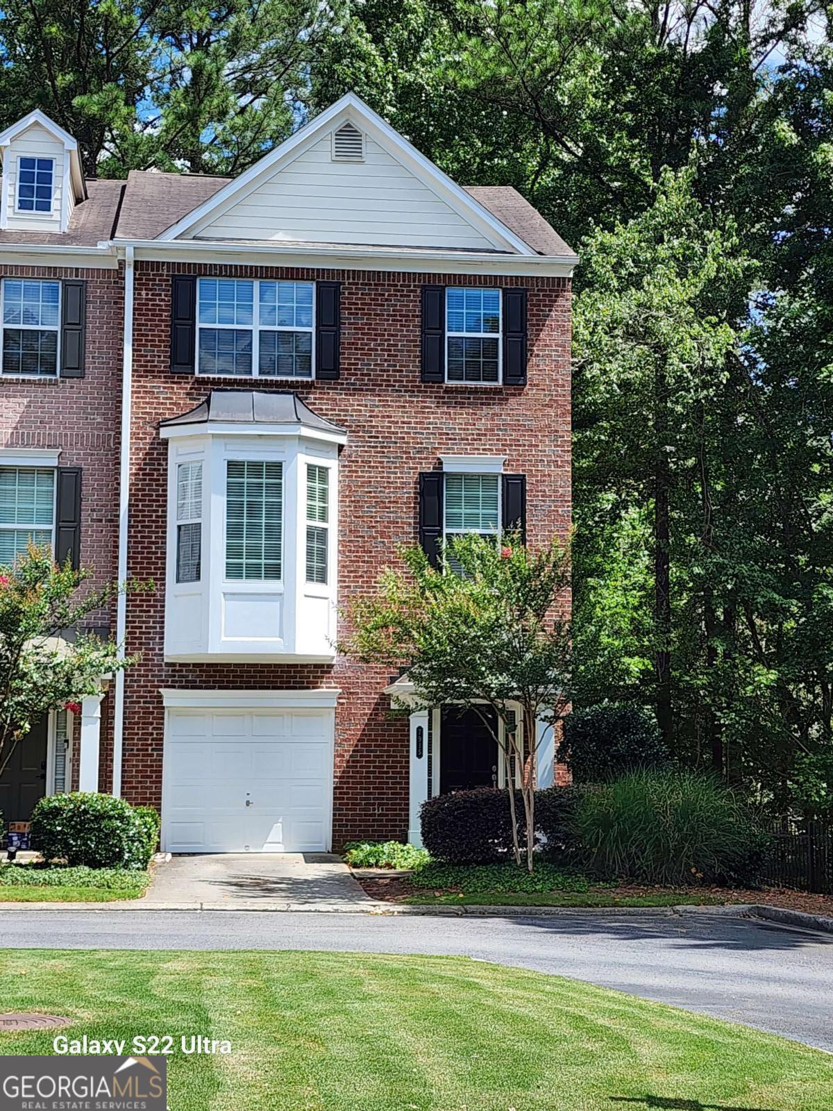 Discover this end unit townhome in the vibrant heart of Sandy Springs-where suburban charm meets urban convenience. Enter Cambridge, a private, gated community with tree-lined streets and blooming crape myrtles. Your future home welcomes you with a covered porch shaded by mature trees. Inside, sunlight pours into the terrace level, featuring a flexible ensuite with a finished bedroom and full bath - perfect for guests, a home office, or workout space. This unique end-unit townhome boasts windows on all three sides, flooding each floor with natural light. Hosting gatherings are a delight in the open upstairs living area, which seamlessly connects the bright eat-in kitchen and breakfast bar for a quick breakfast, coffee or snack. The adjacent dining room, cozy living room and large windows overlook a private wooded backyard and deck, offering a peaceful retreat for relaxation or entertainment, and an ideal layout for casual or formal gatherings. As night falls, and with a flip of a switch - the gas fireplace glows, setting the mood for cozy nights. On the top floor, the sun-drenched primary ensuite features a spacious walk-in closet and spa-like bathroom. A generous secondary ensuite provides flexibility for guests or a personal office. This three-sided brick home is situated on a corner lot, and features freshly painted walls, new carpeting, gleaming hardwood floors, new water tank, and upgraded HVAC for hot summer days or cold evenings. Stroll to Morgan Falls Overlook Park and catch a beautiful sunset at the 30-acre riverside park that offers picnic pavilions, playground, boat dock with direct access to the Chattahoochee River, hiking trail, and scenic views. Golf enthusiasts will love the proximity to Steel Canyon Golf Club, an 18-hole public course. Top restaurants, Perimeter Mall, Sandy Springs Arts Center, Downtown Roswell, Avalon, Buckhead and Downtown Atlanta are only 10 - 15 minutes away, with easy access to GA400, I-285 and Roswell Road. Welcome to your move-in ready home or income property offering comfort, convenience, privacy, and a vibrant lifestyle.