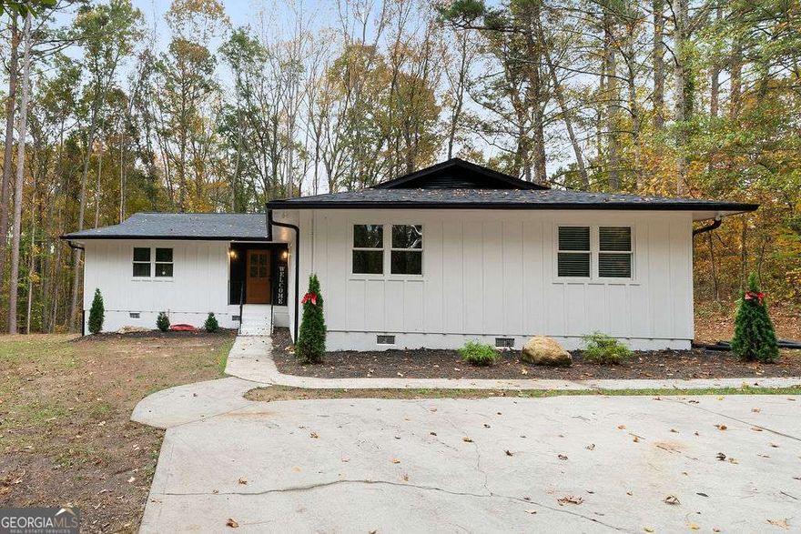 Look no further! Amazing opportunity to own a hidden gem in the desirable heart of West Cobb. This 4br 2bath open concept home has everything that you are looking for and more... As you enter the home, you will notice all the love and hard work that was put into this home to make it a place to call home! The kitchen features an oversized kitchen island with a built in, and one of a kind microwave, new stainless-steel appliances, beautiful white cabinets, quartz countertops and tile backsplash. The dining area has plenty of space to host a gathering. The inviting, large living room features, a fireplace and an oversized window to enjoy the view to the backyard and nature! The owner's suite offers an elegant accent wall, a huge walk-in closet, and a stunning bathroom with double vanities. The three secondary bedrooms are very commodious and with ample closet space and lots of natural light. The exterior of the home features, a deck to grill or to sit out and enjoy the peaceful feeling of the serene backyard, and with an acre of land... the possibilities of what you can do there are endless, like build a pool, gardening and so much more! Come tour this home and find out how close you are to the West Cobb Avenues, and all the shopping and dining around the area, you will be amazed!!