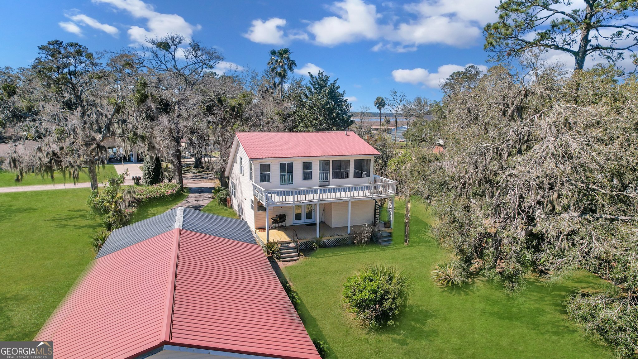 Seller says SELL IT !! $25,000 Price REDUCTION! Escape to a MARSH front retreat on Colonel's Island, near Savannah, GA. This renovated 2,100-square-foot home, built in 1985, blends elegance with coastal charm. It features a durable metal roof and a deep-water dock access with boat lift, perfect for boating, fishing, or enjoying sunsets. Inside, a master suite upstairs offers a balcony, a spa-like bathroom with a soaking tub and luxury tile walk-in shower, and an expensive walk-in closet, while an extra bedroom downstairs comes complete with its own renovated full bathroom featuring a luxury tile shower. The living area boasts a cozy gas fireplace, while the gourmet kitchen shines with granite countertops and updated, all-stainless-steel appliances that will stay with the property-ideal for relaxation or entertaining. Outside, an expansive deck and marsh-side porch create the perfect setting for unwinding or hosting, paired with a landscaped yard and a spacious garage for storage or hobbies. Nestled in a peaceful and private neighborhood, this retreat offers tranquility and convenience, making it an ideal forever home or your next island getaway.