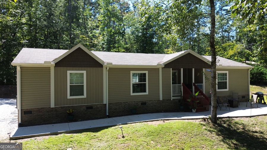 This great Lake Hartwell home offers ultimate privacy on 1.86 acres with over 800' on the corps line. The interior condition and finish level are excellent and all furnishings are included. The bright kitchen is open to the dining area and great room. The owner's suite is lakefront, and the bath has double vanities and a separate tub and shower. The split bedroom plan has two bedrooms (1 lakefront) and a full bath on the other end of the home. There is a covered porch overlooking the lake and a gentle walk to the covered slip dock with PWC lifts. This property also includes a detached 2 car garage which is currently being used as a shop. There is an additional storage shed for all your lake toys. This property will be the perfect match for the outdoorsman that wants some extra elbow room.