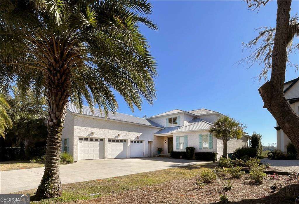 Boating, fishing, kayaking, or golfing... you can pick! Location, location, location! Custom built home, offering 4109 sf. Hand scraped Russian White Oak floors throughout. Primary bedroom on main with his and hers baths and large walk-in closets. 3 bedrooms upstairs, each with en-suite bathrooms and walk in closets. Spacious bonus room with full bathroom & queen bed over the large 3-car garage. Gourmet kitchen for the most demanding buyers. Open floor plan. A few other features are 2 ice makers, wet bar 4 bottle wine dispenser, large walk-in pantry, 2 laundry rooms, deeded boat slip. The outdoor space is heaven! Views of Jekyll Island and the intracoastal water way. Covered porch with wood burning fireplace. Gas heated saltwater pool with jetted seating area. Too many features to mention them all. Make this property your home in Yacht Club, a gated residential subdivision on the South end of Saint Simons Island.