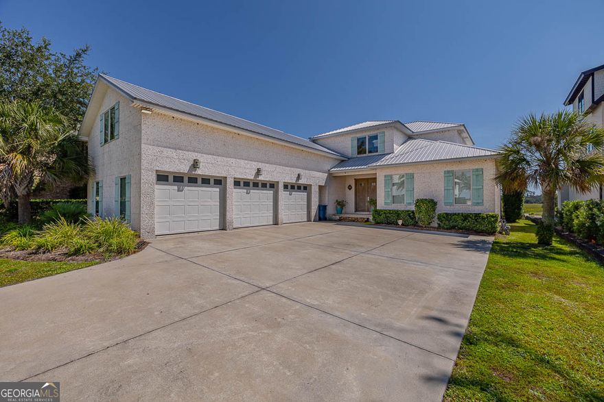 Boating, fishing, kayaking, or golfing... you can pick! Location, location, location! Custom built home, offering 4109 sf. Hand scraped Russian White Oak floors throughout. Primary bedroom on main with his and hers baths and large walk-in closets. 3 bedrooms upstairs, each with en-suite bathrooms and walk in closets. Spacious bonus room with full bathroom & queen bed over the large 3-car garage. Gourmet kitchen for the most demanding buyers. Open floor plan. A few other features are 2 ice makers, wet bar 4 bottle wine dispenser, large walk-in pantry, 2 laundry rooms, deeded boat slip. The outdoor space is heaven! Views of Jekyll Island and the intracoastal water way. Covered porch with wood burning fireplace. Gas heated saltwater pool with jetted seating area. Too many features to mention them all. Make this property your home in Yacht Club, a gated residential subdivision on the South end of Saint Simons Island.
