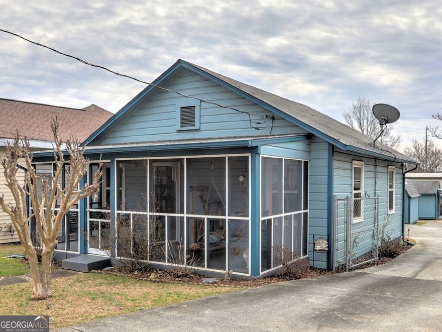 Great investment opportunity within a mile of Marietta Square! This home is now zoned Light Industrial Commercial.  This 2 bedroom, 1 bathroom home was built in 1950.  The owner acquired the neighboring lot, which is primarily open space. Due to the fact there is an existing residential home in a now commercially zoned area, the home has a grandfathered status with restrictions regarding improvements and changes. The possibilities with this investment are endless!