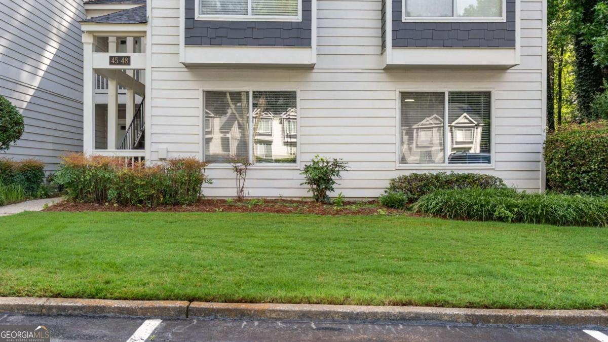 Beautiful 2BR/2BA End Unit Condo - Prime Location Near Truist Park! Spacious and stylish, this updated stepless end-unit condo offers comfort, convenience, and charm all in one. Featuring 2 bedrooms and 2 full baths-including a primary suite with a step-free walk-in shower-this home is designed for easy, low-maintenance living. The modern kitchen features granite countertops, a deep farmhouse sink, and a dedicated coffee or wine bar-perfect for relaxing or entertaining. Enjoy the open-concept living area with a cozy fireplace and a separate dining room that also makes an ideal home office. Additional perks include an in-unit washer and dryer, no stairs, and resort-style community amenities like a pool and fitness center. A runner's dream location-just minutes to Truist Park, The Battery, public transit, shopping, dining, and easy access to I-75 and I-285. Modern living, unbeatable location-welcome home!