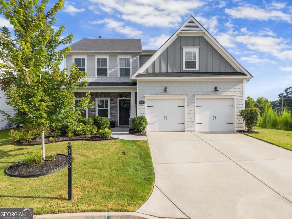 Welcome to your dream home in the highly sought-after Lake Haven community in North Forsyth County! Built in 2020, this stunning 5 bedroom, 4 bath home sits on a quiet cul-de-sac lot and is less than a mile from the brand-new Sawnee Mountain Park. Step inside to discover a spacious open-concept layout featuring an eat-in kitchen with granite countertops, gas range, breakfast bar, and a separate formal dining room perfect for entertaining. A bedroom and full bath on the main level offer convenience and flexibility, while the living room boasts a gorgeous stone fireplace creating a cozy, inviting atmosphere. Upstairs, you'll find an oversized master retreat complete with two walk-in closets, a spa-like bathroom with dual vanities, separate tub and shower, and a private laundry room. Three additional upstairs bedrooms all feature walk-in closets, including one with its own ensuite bath, plus a hall bath for added comfort. Outside, the backyard is a true oasis - fully fenced and packed with upgrades: professionally leveled and elevated, complete with pavers, lush landscaping, new grass, French drains, a covered patio, and a gas line ready for your grill or outdoor kitchen. Enjoy resort-style neighborhood amenities including a clubhouse, Olympic lap pool with kiddie pool, tennis & pickleball courts, playground, green space, and private lake access with a dock and hiking trails. This home offers the perfect blend of luxury, function, and lifestyle in one of Forsyth's premier communities. Don't miss your chance to call it home!