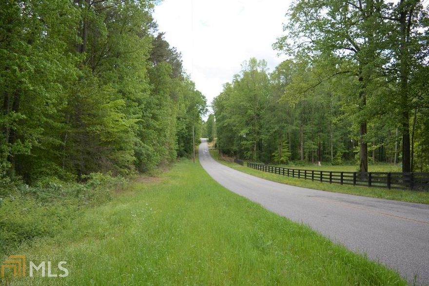 Gorgeous wooded and rolling tract in desirable Free Home area of eastern Cherokee County. 21.45 acres with gently rolling topography, small stream, and primarily hardwood timber with few pines. Ideal setting for a hobby or horse farm or development for custom homes with acreage tracts. This is an idyllic setting that offers quiet country living surrounded by small farms and custom homes. County water, cable & internet, power, and natural gas available. Peace and quiet, but convenient to Cumming and Canton and other amenities nearby. You will love it here, I promise! Put on your boots, let's go!