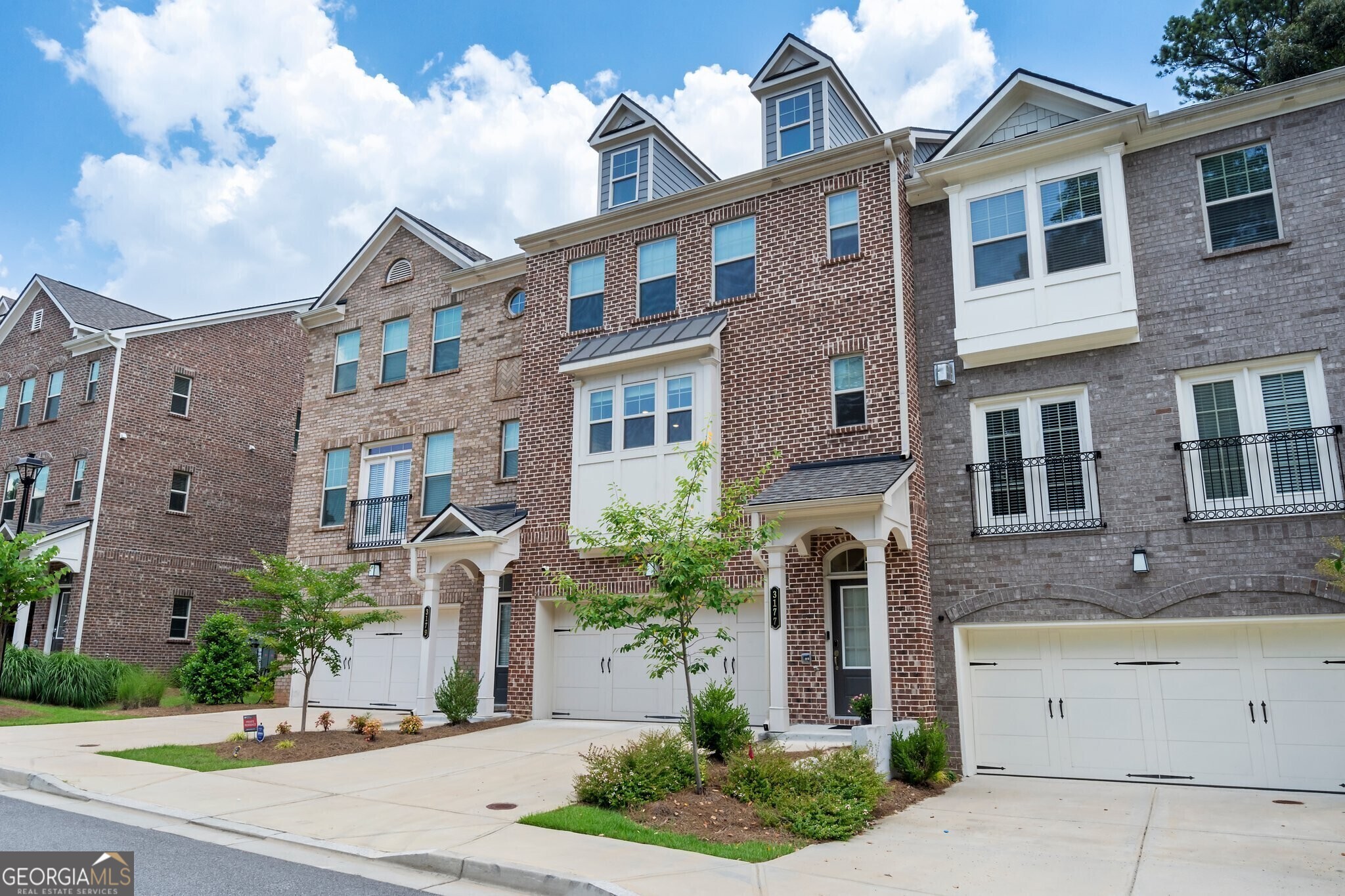 Absolute perfection tucked away on quiet, tree-lined, street in secure, and gated community of Clairebrooke in highly desirable Chamblee! This stunning, furnished optional, townhome is one of the few larger floorplans in the community with tons of designer upgrades. When you walk in, this one feels different than your average townhome with tons of natural light, a bright and fresh feel and the tasteful design touches throughout knock your socks off immediately. Huge kitchen with stainless applainces, quartz countertops, and custom cabinetry, hardware, and lighting opens to stunning breakfast area open to a sophisticated yet comfortable family room. Fireside living opens to a private balcony overlooking the trees and greenspace perfect for a pet or just having coffee with nature surrounding you. Spacious primary suite upstairs with double vanity and huge shower with seating and walk in closet. Laundry room in hallway, and two secondary bedrooms with full bath upstairs. Media room or fourth bedroom on terrace level with millwork and designer lighting with full bath and open to green space. Two car garage outfitted with tesla charger perfect for meeting all of your needs. The location is prime with its close proximity to charming downtown Chamblee, Blackburn Park, and the new Dresden Park, shopping, restaurants, and more! This pristine community has a dog run and fire pit gathering area made for making great memories with neighbors, family, and friends! NO rental restrictions.