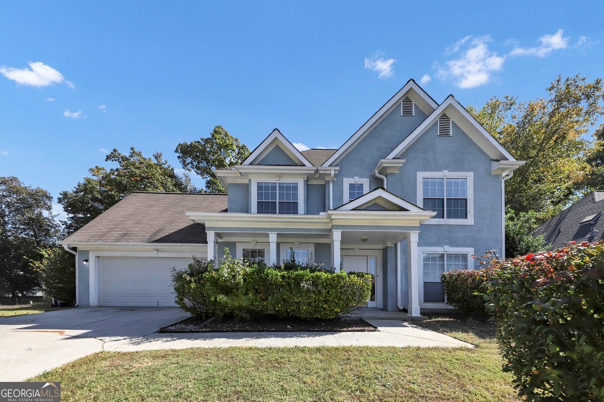 Welcome to this 4-bedroom, 2.5-bath, 2,308 sqft single-family home nestled in the highly desirable Parkside community. This stunning two-story residence combines style and comfort with a beautiful blue exterior, accented by white trim and a welcoming front porch with elegant columns. The meticulously maintained front yard, lush with greenery and manicured bushes, offers inviting outdoor enjoyment, while a spacious two-car garage provides convenient parking. Multiple saddled and a pitched roof add architectural elegance, giving this home exceptional curb appeal. Step inside to a spacious, open living room featuring light brown walls, a subtle textured ceiling, and two ceiling fans with lights for enhanced comfort. Wood-like flooring lends warmth, while large windows with white blinds fill the room with natural light, creating an inviting ambiance. This flexible, open layout is perfect for both relaxation and entertaining, with a staircase featuring white railings leading to the upper floor, adding a touch of sophistication. At the heart of the home, the modern kitchen shines with sleek white cabinetry, countertops, and top-of-the-line stainless steel appliances, including a refrigerator with water and ice dispenser, a gas stove, and a microwave. A large island serves as an ideal prep space and casual dining spot, while a mosaic tile backsplash in warm tones adds an elegant accent. Ample natural light fills the room through a window above the sink and double doors leading to additional spaces, making this kitchen a welcoming hub for cooking and gathering. Adjacent to the kitchen, the dining room offers an elegant space with neutral beige walls, white trim, and a charming chair rail. Two large windows with white blinds allow natural light to enhance the room's warm and welcoming atmosphere, while a sophisticated chandelier and dark floors create an inviting setting for family meals and entertaining guests. The spacious primary bedroom serves as a tranquil sanctuary with soft beige walls, white trim, and ample room for a king-sized bed and additional furniture. Light floods through a large window dressed with white curtains, while a ceiling fan with an overhead light ensures comfort. This room's restful ambiance provides the perfect retreat for unwinding. The luxurious primary bathroom feels like a spa with a double-sink vanity, sleek white countertops, and chrome faucets. Two large mirrors with light fixtures offer excellent illumination, while a glass-enclosed shower and a separate bathtub with a tiled surround create a serene environment. The bathroom also provides easy access to a walk-in closet with built-in shelving, ideal for organized storage. Experience the beauty and comfort of this exceptional property in Parkside! Schedule your private showing today and envision your life in this inviting and stylish home.