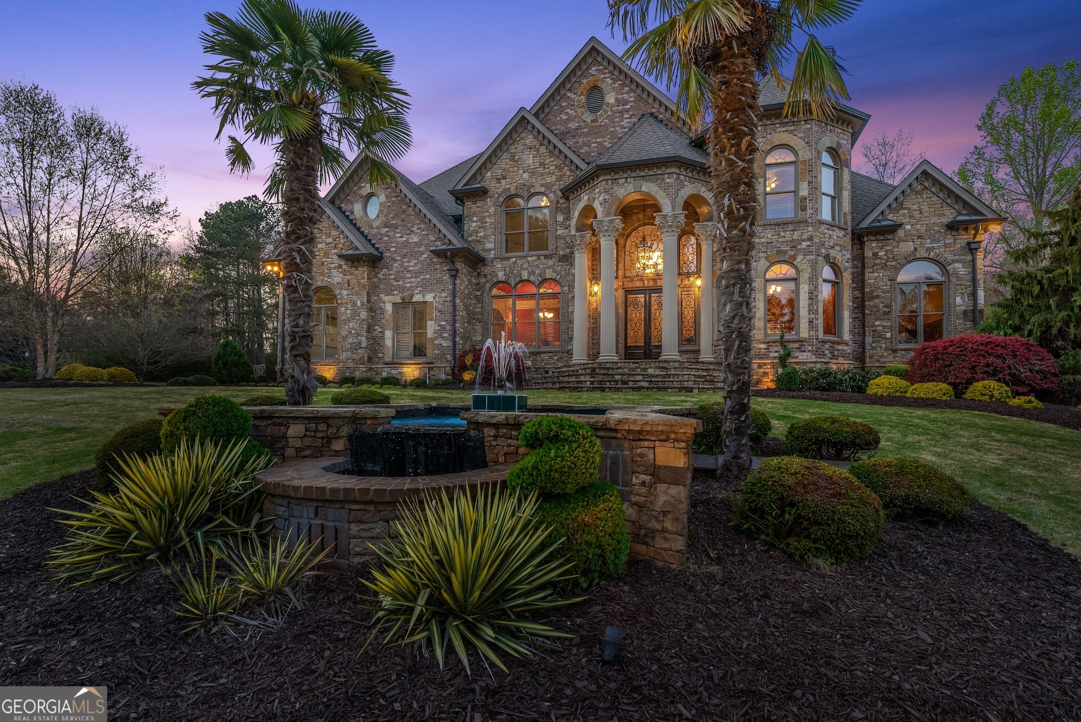 This Is More Than A Home-It's A Must-See Luxury Estate That Defines Timeless Elegance And Refined Living. Perfectly Positioned In South Forsyth's Prestigious Lambert High School District, This Exceptional 1.09-Acre Property Offers The Rare Combination Of Privacy, Space, And Sophistication-With No Hoa Restrictions. Built With Enduring Four-Sided Brick And Accented By Classic Stonework, The Home Makes A Striking First Impression That Only Deepens Inside. A Dramatic Two-Story Foyer With A Sweeping Spiral Staircase Welcomes You Into A World Of Grandeur, While Floor-To-Ceiling Windows Flood The Living Room With Natural Light And Frame Breathtaking Views Of The Landscaped Grounds. The Gourmet Kitchen-Featuring Dual Oversized Islands, Top-Tier Appliances, And Custom Cabinetry-Is The Heart Of The Home, Designed For Both Everyday Luxury And Upscale Entertaining. Cozy Up In The Vaulted Family Room With A Stacked-Stone Fireplace, Or Find Inspiration In The Richly Appointed Library And Executive Office. The Primary Suite Is A Sanctuary Unto Itself, Complete With A Private Minibar, Spa-Like Bath, And Dual Custom Closets. Each Secondary Bedroom Includes A Private En-Suite, Ensuring Comfort And Privacy For All. The Fully Finished Terrace Level Rivals Any Luxury Resort With A Home Theater, Second Kitchen, Billiards Room, Gym, Cedar Sauna, And Fireside Lounge. Outside, A Custom Masonry Deck, Professional Landscaping, Landscape Lighting, And A Spacious Driveway Set The Scene For Unforgettable Gatherings. Ideally Located Near Top Schools, Dining, And Parks-This Is A Once-In-A-Lifetime Opportunity To Own One Of Forsyth County's Finest Homes.