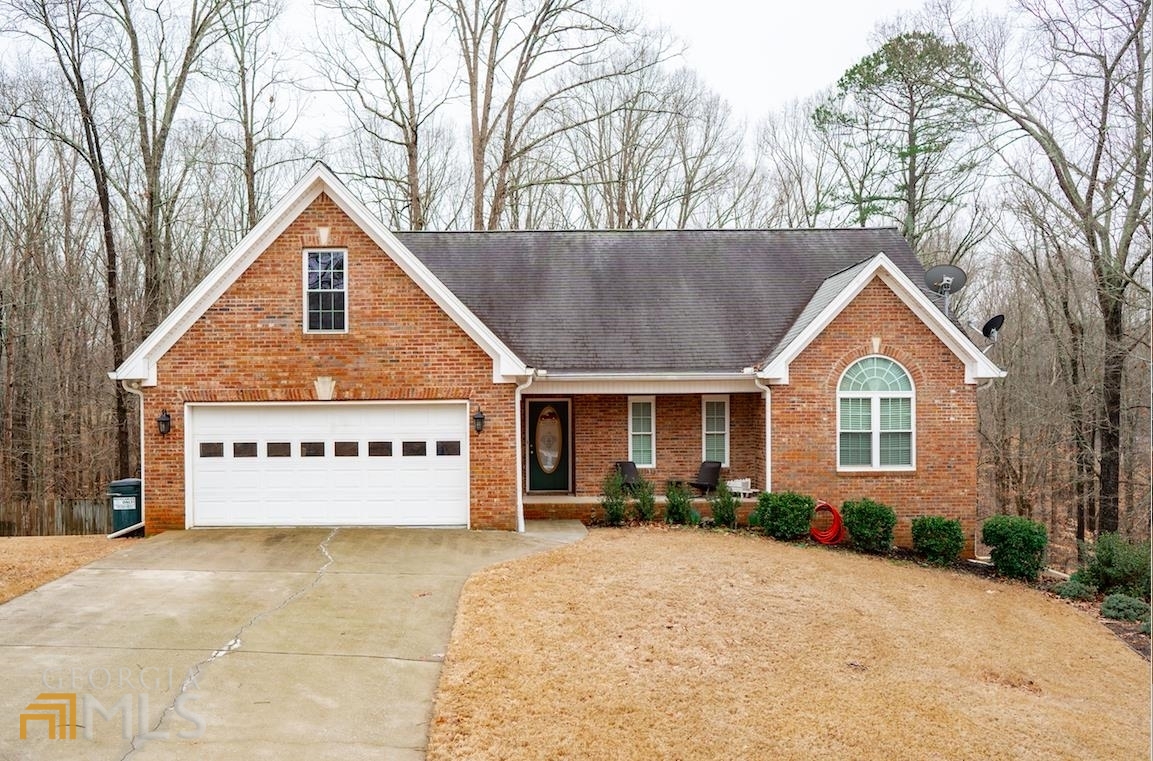 Welcome home to your beautiful, updated, MOVE-IN-Ready ranch style home located in the sought after neighborhood of Stone Creek. Single-floor living offers ease and convenience in this lovely 5-bedroom, 3-bathroom ranch-style home with a FULL Finished daylight basement. Enjoy coming home to your welcoming brick front porch and large professionally landscaped front yard. Entering the home you are greeted by the show stopping floor to ceiling stone fireplace and oversized living room. To your right you will find a hall that leads to your restful primary bedroom that includes a walk-in closet and updated private bath with separate tub and shower and double vanity. The two additional bedrooms on the main floor share a separate updated bathroom. Overlooking the living room is the open concept dining room and updated kitchen that is stylish, spacious and bathed in natural light offering practical functionality in an efficient layout. The granite countertops and breakfast bar are exceptional. There are also a newer stainless steal appliances. The walk-out basement serves as rec room, multi-purpose room, guest rooms, and even has another 3rd garage entrance with private 2nd driveway that is currently used as a work shop and boat storage. Other great exterior features include the wood deck with steps to your massive fenced in backyard and a patio below. The home is just a short drive to West Jackson Highschool, shopping, dining, & Traditions Golf Club. Have fun packing this one full of warmth and memories. ** Walkthrough Video Coming soon!**