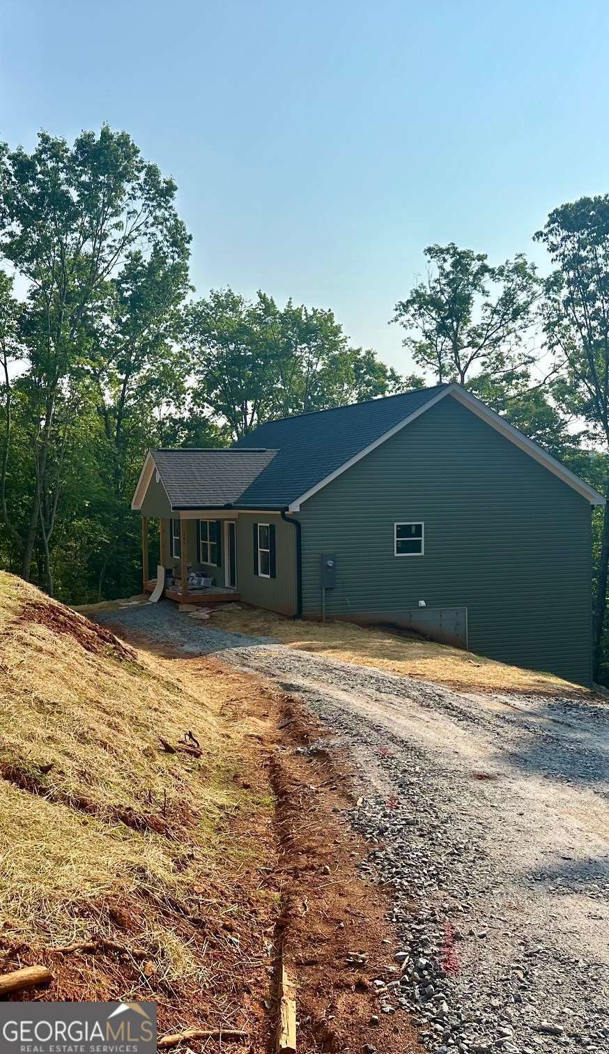 Last unit left in the highly sought after Tower Drive community off Auraria Rd in Dawsonville/Lumpkin County. This new construction 4 master suite plan will be ready for FALL! Move in August 1st, $2800 per moth or $700 per bedroom. 10 mins to UNG or Dahlonega! Safe area, easy access to Dawsonville & 400. Spacious upgraded plan. 2 oversized en-suites upstairs, and 2 downstairs. 2 living spaces, covered front & rear porches! Granite, Lifeproof flooring, vaulted ceilings, full laundry room, unfinished storage, county water, and in a community of similar styled new unites. Lawn upkeep is included. These don't ever last long, this one just happened to come back available. Call today! We have more completed units available to tour.