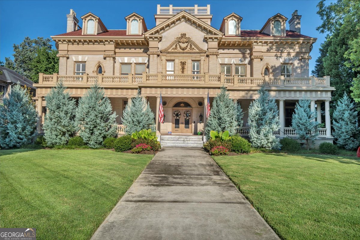 Step into history and luxury at the McCaw/Massee Estate-known locally as the "Crisco House." This Family home is nestled in the heart of Macon, Georgia-just over an hour from Atlanta-this breathtaking estate combines historic significance with modern elegance in one of the Southeast's most desirable and affordable cities. Completely restored from rooftop to foundation, the mansion showcases soaring ceilings, rich hardwood floors, striking stonework, and a one-of-a-kind architectural staircase that greets guests in the grand foyer. Steeped in legend, it is said that Tennessee Williams found inspiration here for his "Big Daddy" character in Cat on a Hot Tin Roof. This estate offers every luxury imaginable: a speakeasy-style bar, state-of-the-art gourmet kitchen, private theater, elevator to all floors, and a spacious two-bedroom, two-bath apartment with its own kitchen and living area. A charming guest cottage, brick-enclosed private backyard, expansive porches, and elegant verandas make it ideal for entertaining or quiet retreats. Known as the crown jewel of College Street, 619 College Street is more than a mansion-it is a timeless Southern masterpiece that embraces you with warmth, grandeur, and hospitality like no other.