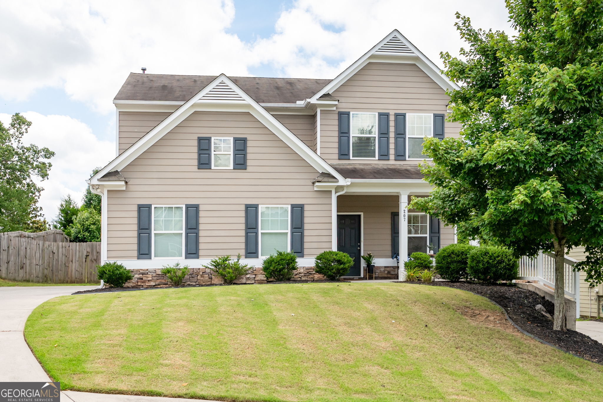Charming, Move-In Ready Home in Prime Location! Welcome to your next chapter in the highly sought-after High Shoals neighborhood! This beautifully maintained home offers low-maintenance living with a private, fenced backyard-perfect for pets, grilling, gardening, or simply relaxing after a long day. Pull into your long driveway that showcases your side entry 2 car garage. From there you will step onto the oversized covered front porch, an ideal spot to enjoy your morning coffee, wave to your friendly neighbors, or unwind in the evening breeze. Inside, you'll be greeted by neutral tones and hardwood floors that flow throughout the main level and upstairs hallway, including the owner's suite. The open-concept floor plan seamlessly blends comfort and functionality-perfect for both everyday living and entertaining. The kitchen features a newer stainless steel gas stove and microwave, a stylish subway tile back splash for easy cleanup, and a large island ideal for meal prep or casual dining. The cozy family room overlooks your peaceful backyard and features a gas fireplace, creating a warm and inviting atmosphere year-round. Upstairs, the spacious owner's suite boasts a tray ceiling, abundant natural light, a spa-like bath with a double vanity, soaking tub, separate glass shower, and a walk-in closet. Three additional bedrooms offer flexibility for guests, a home office, or future needs. You'll also appreciate that the upstairs bathrooms and laundry room have been upgraded to durable and stylish tile flooring-a practical and elegant touch. The side-entry garage provides curb appeal and functionality. All this, just minutes from Lake Allatoona, local parks, campgrounds, grocery stores (6), outlet shopping, and the vibrant downtown areas of Woodstock, Acworth, Kennesaw, and Canton-this location is truly a hidden gem. As a bonus, through a corporate membership agreement with the HOA's management company, you can join BridgeMill Athletic Club at a reduced rate! Membership includes access to the pool, fitness center, group classes, playground, sand volleyball, basketball courts, pavilion, and a variety of kids and family programs. (Ask the listing agent for full details.) Whether you're starting fresh or simplifying life, this home is ready for you-just move in and enjoy!