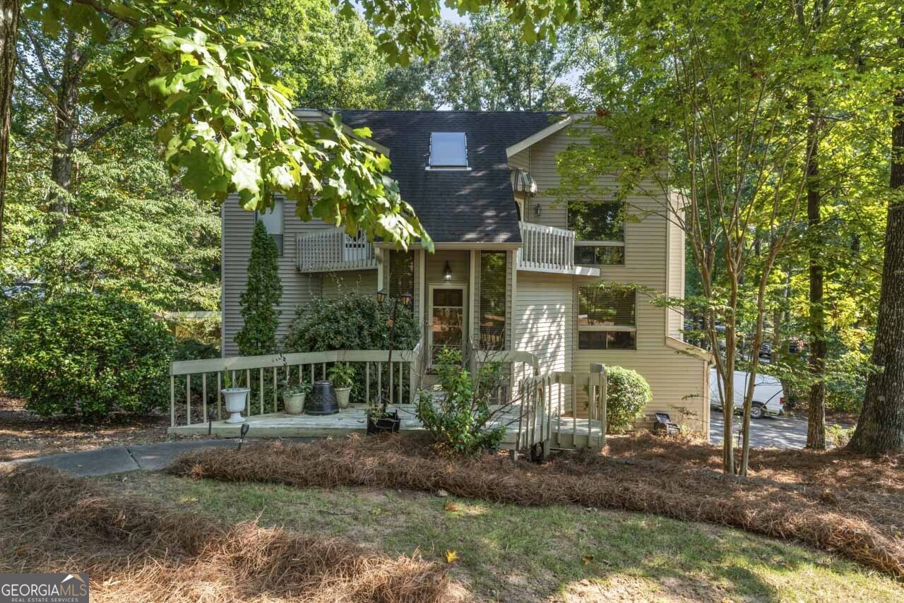 Welcome to your dream home in Marietta, Georgia! The kitchen is equipped with stainless steel appliances, making meal preparation a delight. The living room features floor-to-ceiling windows, flooding the space with natural light and offering picturesque views of the lush surroundings. Step outside to enjoy the covered deck, perfect for outdoor dining and gatherings. This stunning property has an inground pool perfect for summer relaxation and a full finished basement ideal for entertainment or additional living space. This home combines luxury and comfort, providing an exceptional living experience in a sought-after location. Don't miss the opportunity to make this exquisite property your own!