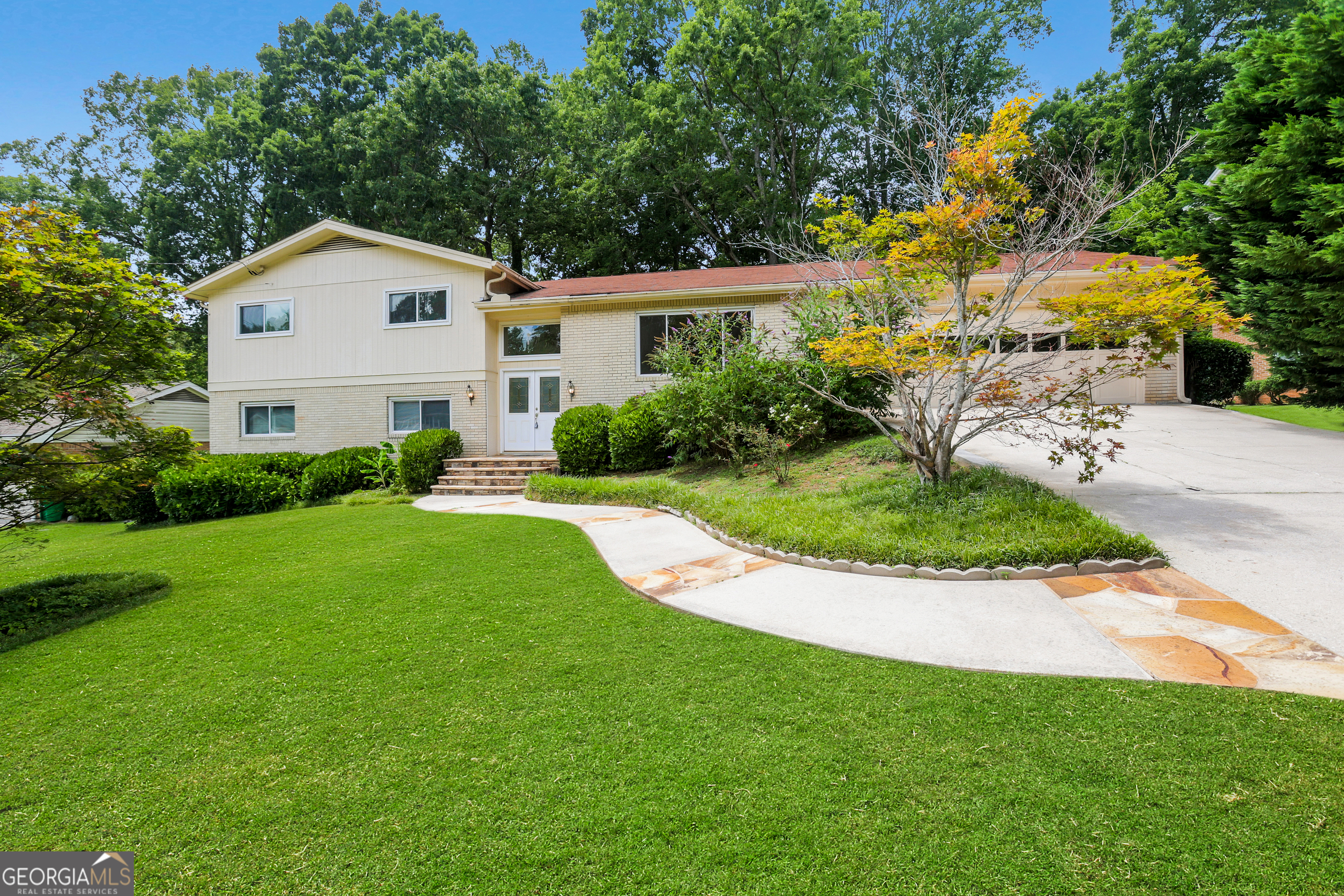 Don't miss this timeless Brick Split-Level in a Prime Dunwoody Location. Welcome to this beautifully 4-bedroom, 3.5-bath split-level, multi-generational home. It is nestled in a quiet, tree-lined cul-de-sac neighborhood with no HOA-just a short walk to both Dunwoody Elementary and Dunwoody High School. Built in 1972, this classic brick home offers timeless character and recent updates. Enjoy gleaming hardwood floors on the main level and a fully remodeled kitchen (2020) featuring granite countertops, a five-burner gas cooktop, double ovens, and all stainless-steel appliances-a true chef's delight. The main level boasts; a spacious den/family room, formal dining room, and eat-in kitchen. A convenient half bath and laundry room just off the kitchen. Upstairs, you'll find: three generously sized bedrooms and two full bathrooms. Downstairs, a fully finished lower level offers excellent in-law suite or rental potential, featuring a separate entry, a private bedroom and full bath, living room with a full-size kitchen setup (gas and water hookups for stove/oven and refrigerator) Step outside to a large, reconditioned back deck (2025) that overlooks a private, manicured backyard with a peaceful walking path-ideal for morning coffee or weekend gatherings. Additional upgrades include: new HVAC system (2024) and new energy-efficient windows (2023). Located on a quiet dead-end street. This home offers unmatched tranquility with walkability, top-rated schools, no restrictive covenants, and multiple swim and tennis club options. Don't miss this rare Dunwoody gem-schedule your private showing today and experience the perfect blend of classic charm, privacy, and modern convenience!