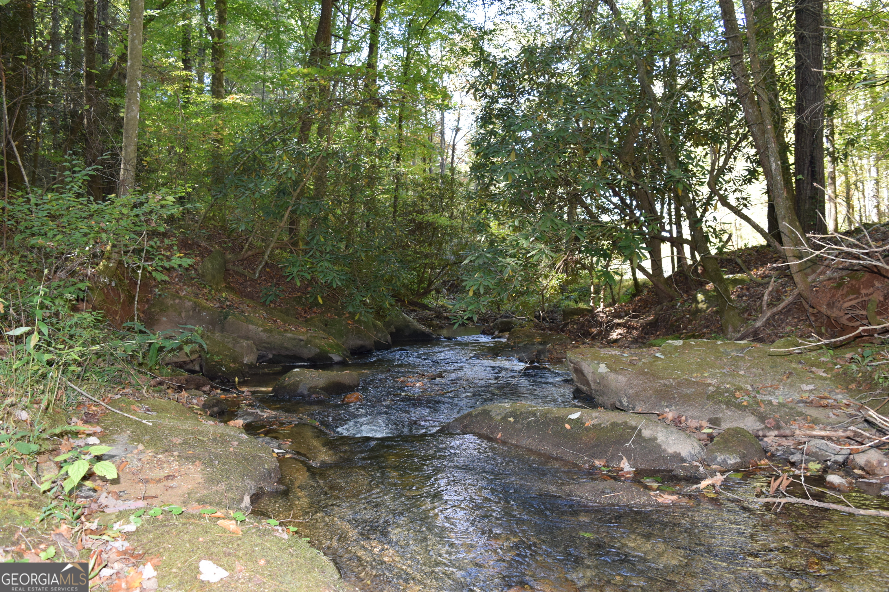 Embrace the beauty of the North Georgia mountains with this incredible 32.98-acre property along Little Mountaintown Creek. With over 2,000 feet of creek frontage as its border, with multiple homesites, and paved road access, this land offers a perfect blend of seclusion and convenience. You'll be surrounded by pristine natural springs, the sounds of the creek cascading along the property, scenic mountain views can be cut in from your homesites, and cleared areas for horses, pastures or garden. The land is ready for you with power nearby, easily accessible established roadbeds, and minimal protective deed restrictions. Imagine building your dream home overlooking the creek, or creating a private retreat for family and friends. The property is ideal for developing 4-5 estate-size lots, each with creek frontage, or simply enjoying as your own private sanctuary. One of the most scenic drives from town leads you to this amazing property with hiking trails galore in this area, and Fort Mountain State Park just down the road, this rare tract of land invites you to enjoy the best of North Georgia living-peace, nature, and endless possibilities. You don't want to miss this tranquil, easy-to-navigate land and see all the possibilities it has to offer!