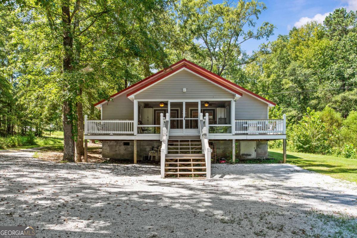 ALMOST 3 ACRES OF LAKEFRONT PARADISE AND PRIVACY WITH INCOME PRODUCING POTENTIAL! Duplex style ranch - 2 identical fully equipped and functional connected dwellings - each with 2 bedroom 1 bath floorplans that give SO MUCH VERSATILITY! Perfect way to spend time together, then have space apart! Both share large screened porch. Stay in one, rent the other... rent them both...buy the property with a friend/family/partner? Short term rent, long term rent.....so many avenues to explore! Additional lake side porch. Adorable firepit relaxation area as well as new double boathouse with double lifts (7000lb and 4000lb) Tucked back in a cove, this property has great access to big water while enjoying the quietness of nature - eagles, fish, deer etc. Pole Barn conveys - tremendous space for any additional buildings etc to be added. Fee simple.