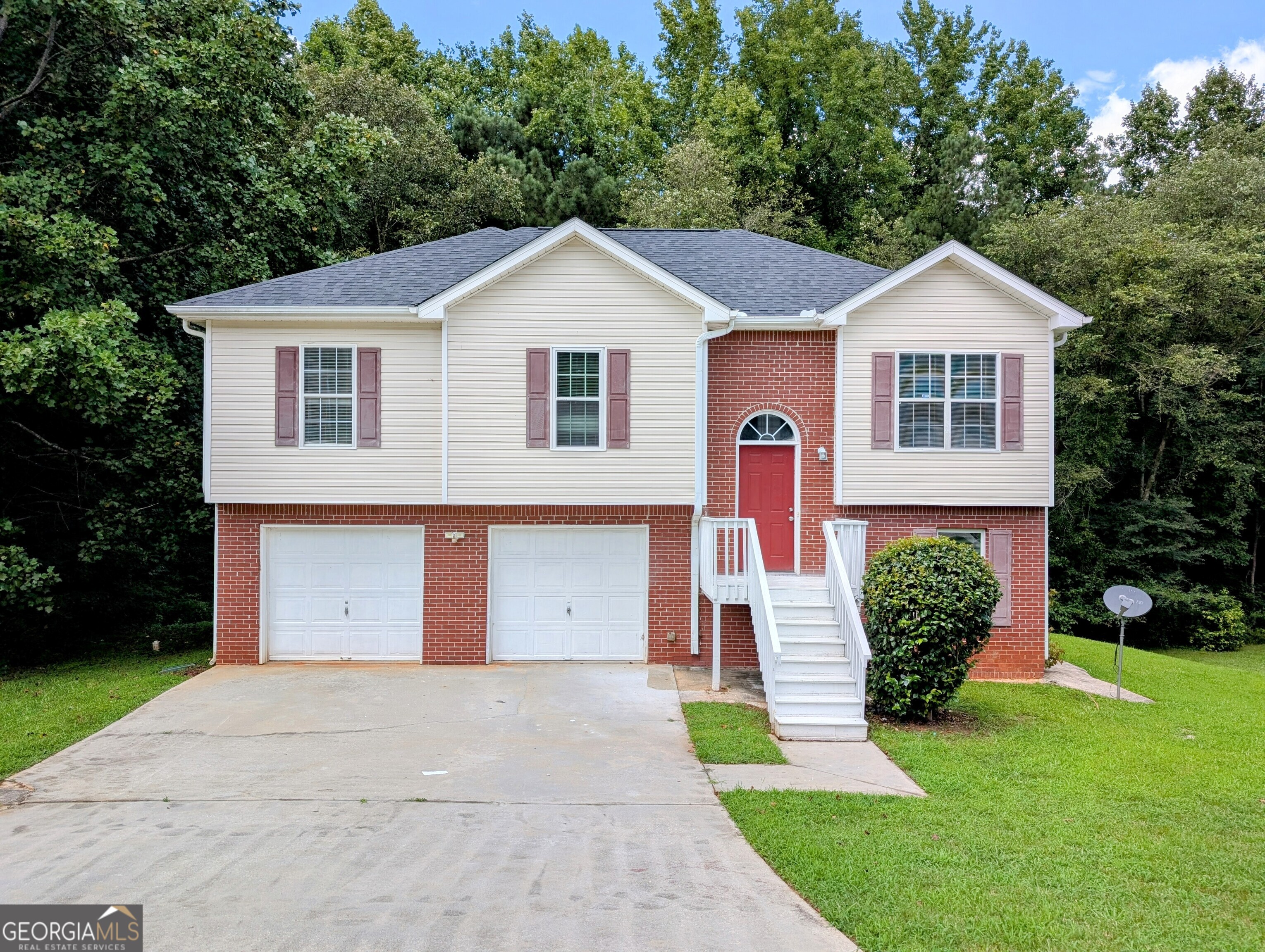 This home is eligible for Special 100% financing with NO PMI & below market rates. A rare 5-bedroom, 3-bath traditional home designed for space, privacy, and flexibility, tucked away in a quiet, established Conyers neighborhood with no HOA restrictions. Sitting on over half an acre, this property is ideal for multigenerational families, in-laws, or anyone needing extra bedrooms and separate living spaces. The layout offers room for everyone to live comfortably without feeling crowded. Inside, you'll find a welcoming floor plan featuring a dining room, family room with fireplace, eat-in kitchen is bright and functional, offering ample cabinetry. The primary suite provides a vaulted ceiling, large walk-in closet, dual vanities, a garden tub, and separate shower. The four additional bedrooms offer plenty of options for extended family, guests, home offices, or even a dedicated homeschool space. With a 2-car garage, classic brick-front curb appeal, and a location just minutes from I-20, shopping, dining, and schools, this home delivers both convenience and comfort for every generation.