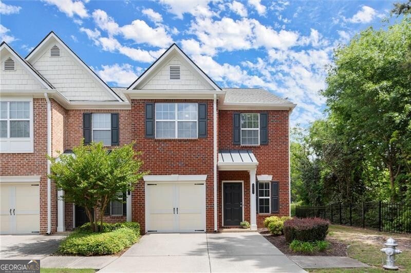 Beautiful End-Unit Townhome in Prime Johns Creek Location - No Rental Restrictions + Top Schools This updated 3-bedroom, 2-bath end-unit townhome combines comfort, convenience, and lifestyle. Located within walking distance to award-winning State Bridge Elementary and Johns Creek High School, where residency is key, this home is ideal for those wanting to secure a spot in one of Georgia's top-rated districts. Enjoy everyday convenience with Publix, Starbucks, Target, and a movie theater just steps away, plus a variety of dining and shopping options nearby. Inside, the open-concept living and dining area welcomes you with natural light and flexibility for entertaining or relaxing. The kitchen offers ample cabinetry, matching appliances, and a window above the sink. Upstairs, the spacious primary suite features a private bath and walk-in closet, while two additional bedrooms offer space for guests, family, or a home office. Step outside to your private patio or take advantage of the community's peaceful amenities, including a small fishing lake, walking trails, gazebo, and playground. A 1-car garage and two additional parking spaces offer plenty of room for vehicles and guests. Additional highlights include in-unit laundry, low-maintenance living, and dedicated parking. You're also just a short drive from downtown Alpharetta, Duluth, Norcross, and Peachtree Corners - truly the best of Johns Creek living. This is a rare opportunity in a sought-after location - schedule your showing today