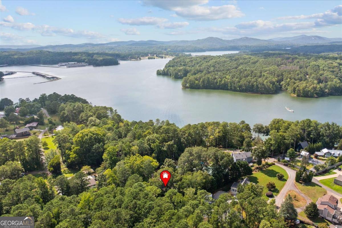 Welcome to your escape to Lake Allatoona. This 3-bedroom, 1-bath home offers over 2,200 square feet of space and includes a lifetime dock lease through the Corps of Engineers for just $25 per year-an exceptional value for lake access. Just a short walk to your own private dock - bring your boat, kayak, or fishing gear and enjoy the lake life full-time or turn this into your next short-term rental investment. With no HOA, you have the freedom to make this property your own. Inside, the home is full of charm, with vintage touches and large windows that bathe the living spaces in natural light. The screened-in porch provides a relaxing, all-season space to enjoy the outdoors without leaving the comfort of home. Step outside to a spacious deck nestled beneath mature trees; ideal for grilling, gathering with friends, or soaking in the peaceful sounds of nature. A lake property that's only 5 minutes to I-75 and 45 minutes from Atlanta - the perfect getaway! Don't miss this opportunity to own a lake property with space, privacy, and unbeatable value. Schedule your private showing today and see how life at the lake could be yours.