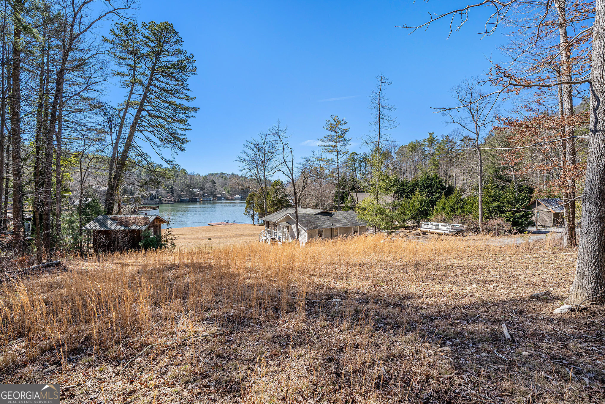 Here is your chance to own one of the largest fee-simple lots on Lake Burton.  This 6 +/- acres would make the perfect family compound or investment property.  The cabin is older, but is still useable. The waterfront is easily accessible with no stairs to get to the current floating dock.  Tons of parking and space to do whatever you desire.  This acreage on Lake Burton does not come around often!